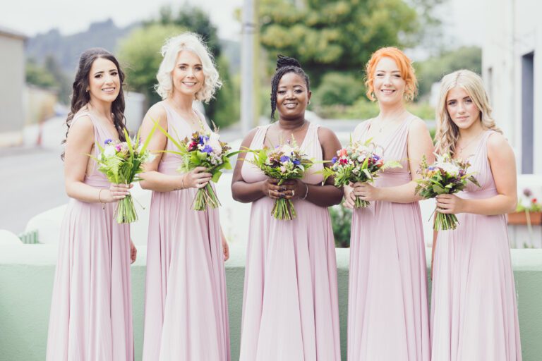 Bride walking through green gardens – JOD Photography