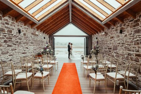 Bride walking on Inchydoney Beach wedding day — JOD Photography