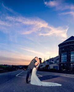 Bride and groom walking hand in hand outside the Celtic Ross Hotel Clonakilty – JOD’Photography