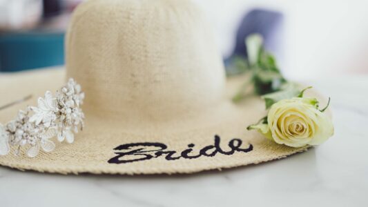 Bride and groom walking through Dunraven Arms Hotel gardens — JOD Photography
