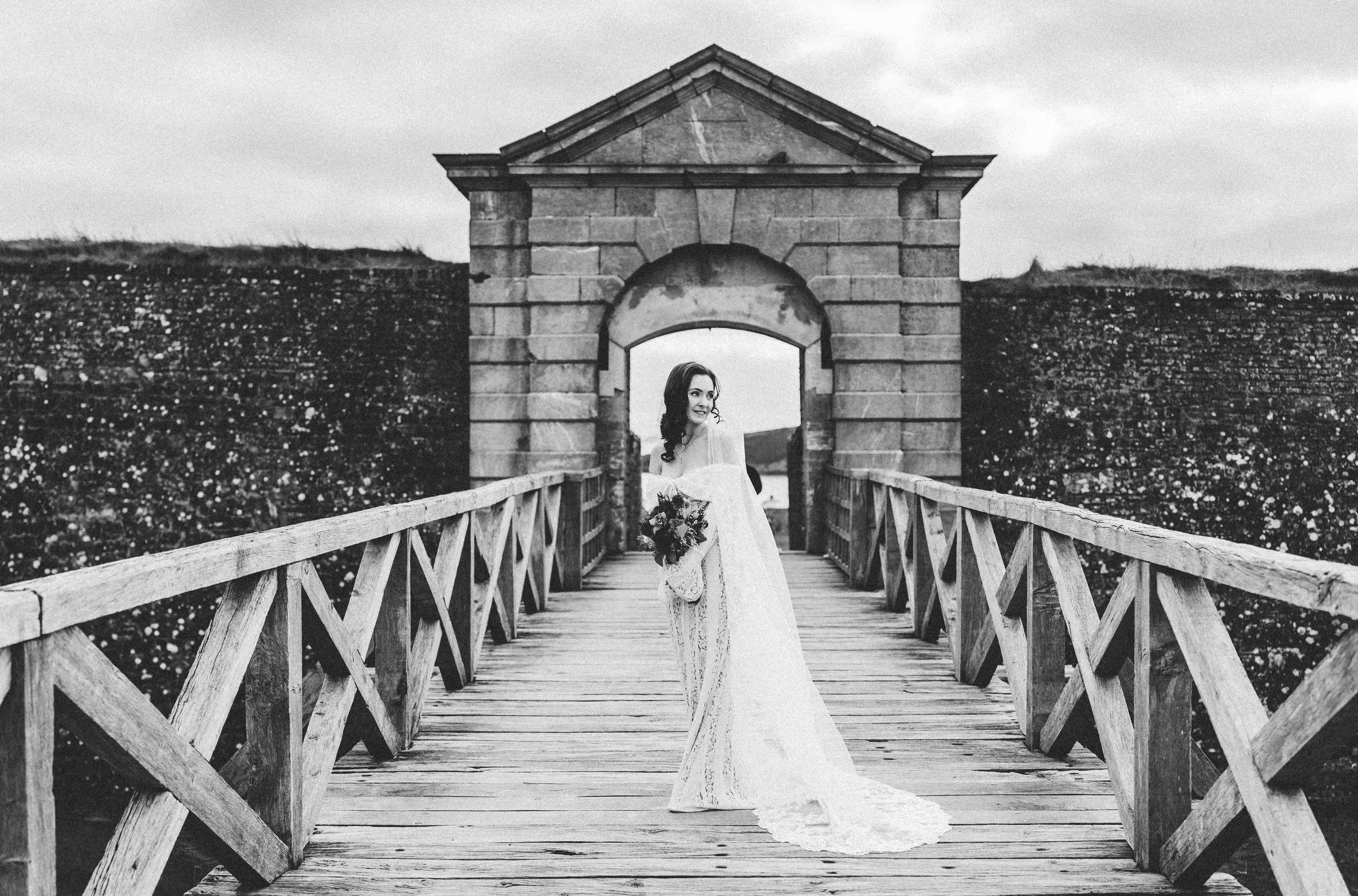 Wedding rings close-up on stone wall at Charles Fort — Kinsale wedding photography — JOD Photography