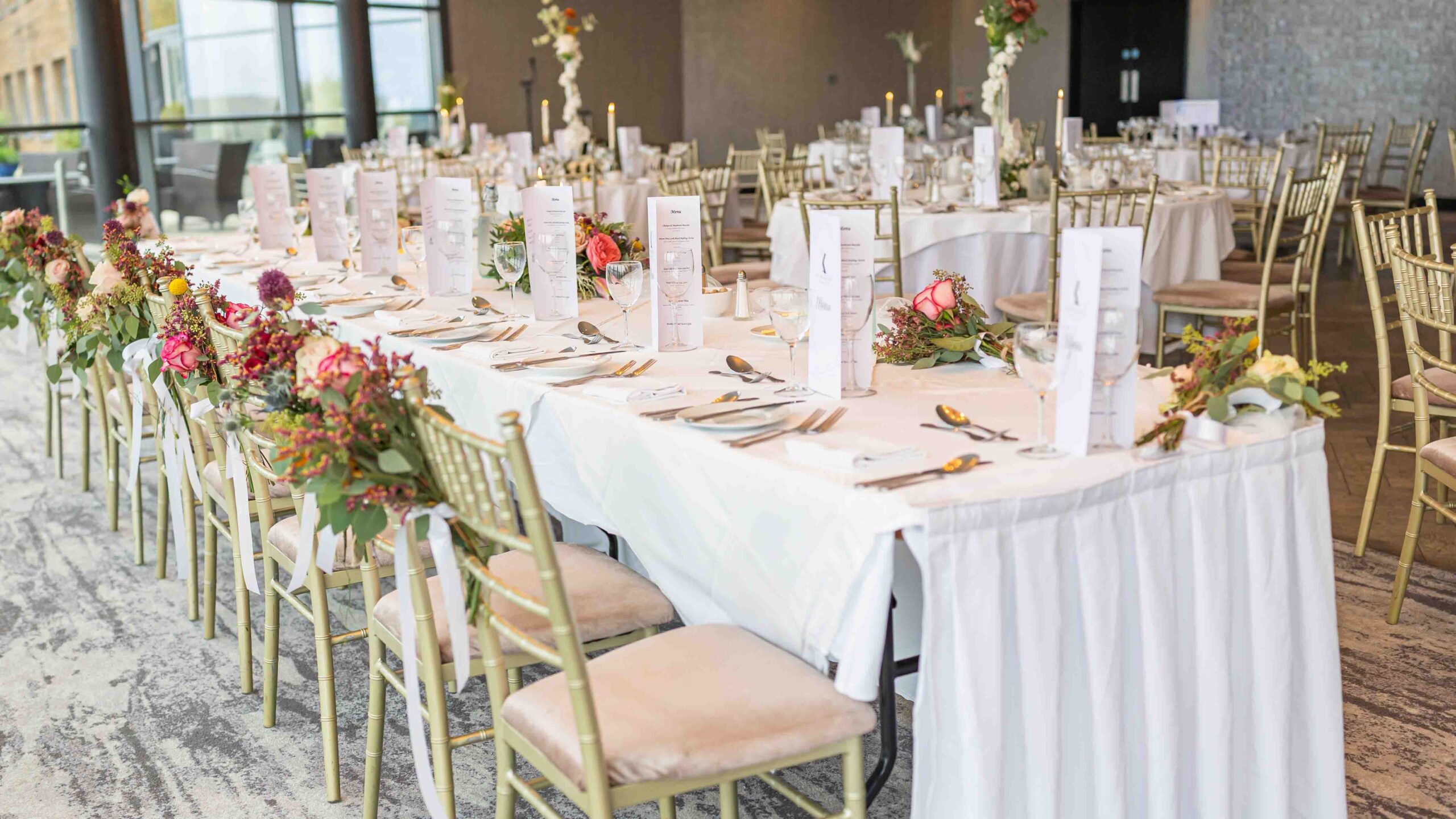 Floral arrangements by Daisy Chain Kinsale on reception tables — Cork wedding photographer — JOD Photography