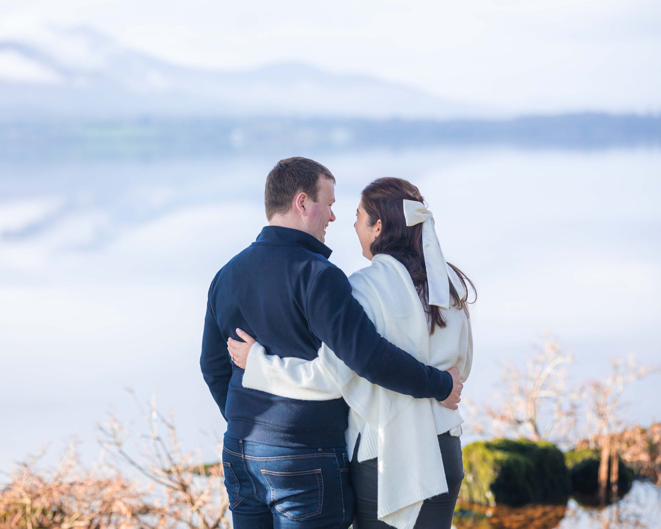 Romantic lakeside engagement photos in Killarney with winter light and mountain views — JOD Photography