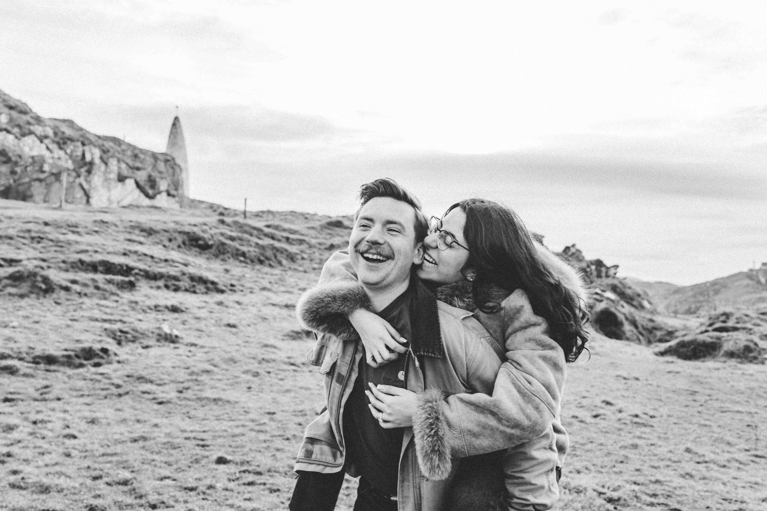 Engaged couple sharing a quiet moment after proposal at Baltimore Beacon, Ireland