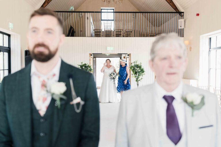Groom and his father waiting at the top of the aisle as the bride arrives, Killarney Heights Hotel