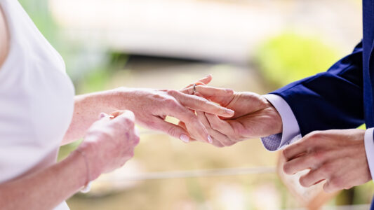 Wedding guests holding umbrellas at Japanese Gardens ceremony
