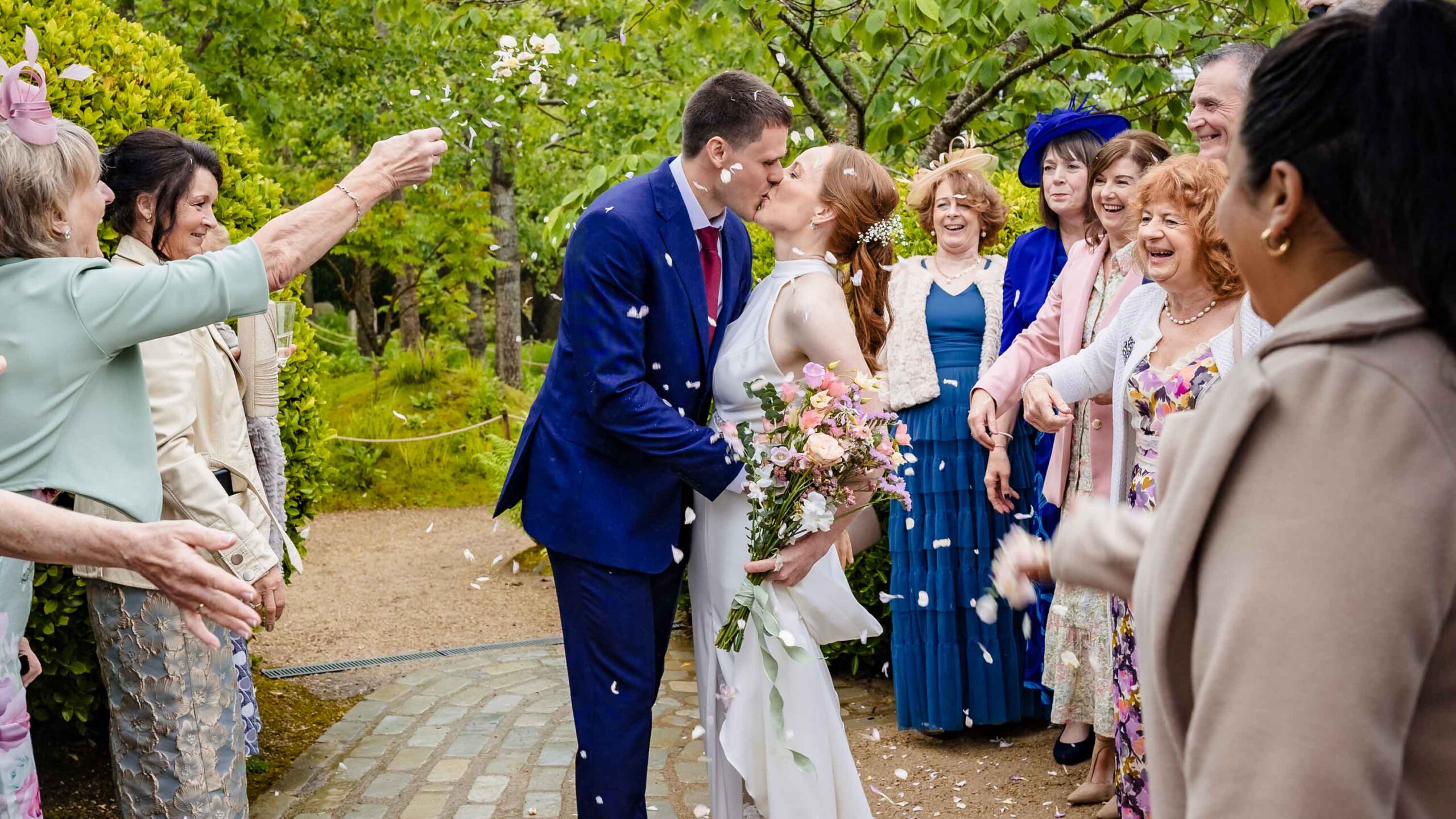 Bride and groom walking through stream gardens