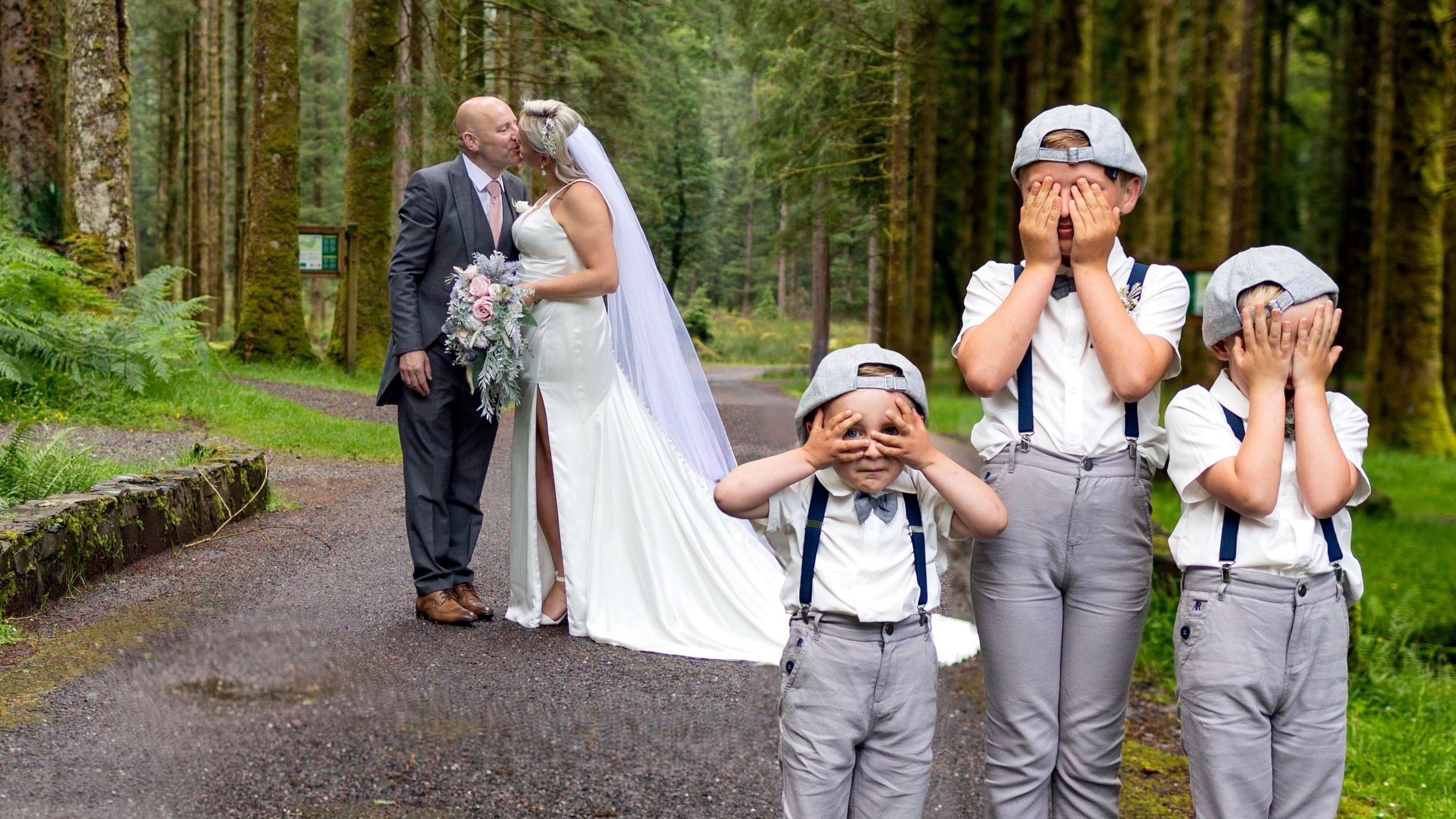 Fun wedding photo at Gougane Barra with flower boys covering their eyes during a forest wedding portrait by JOD Photography