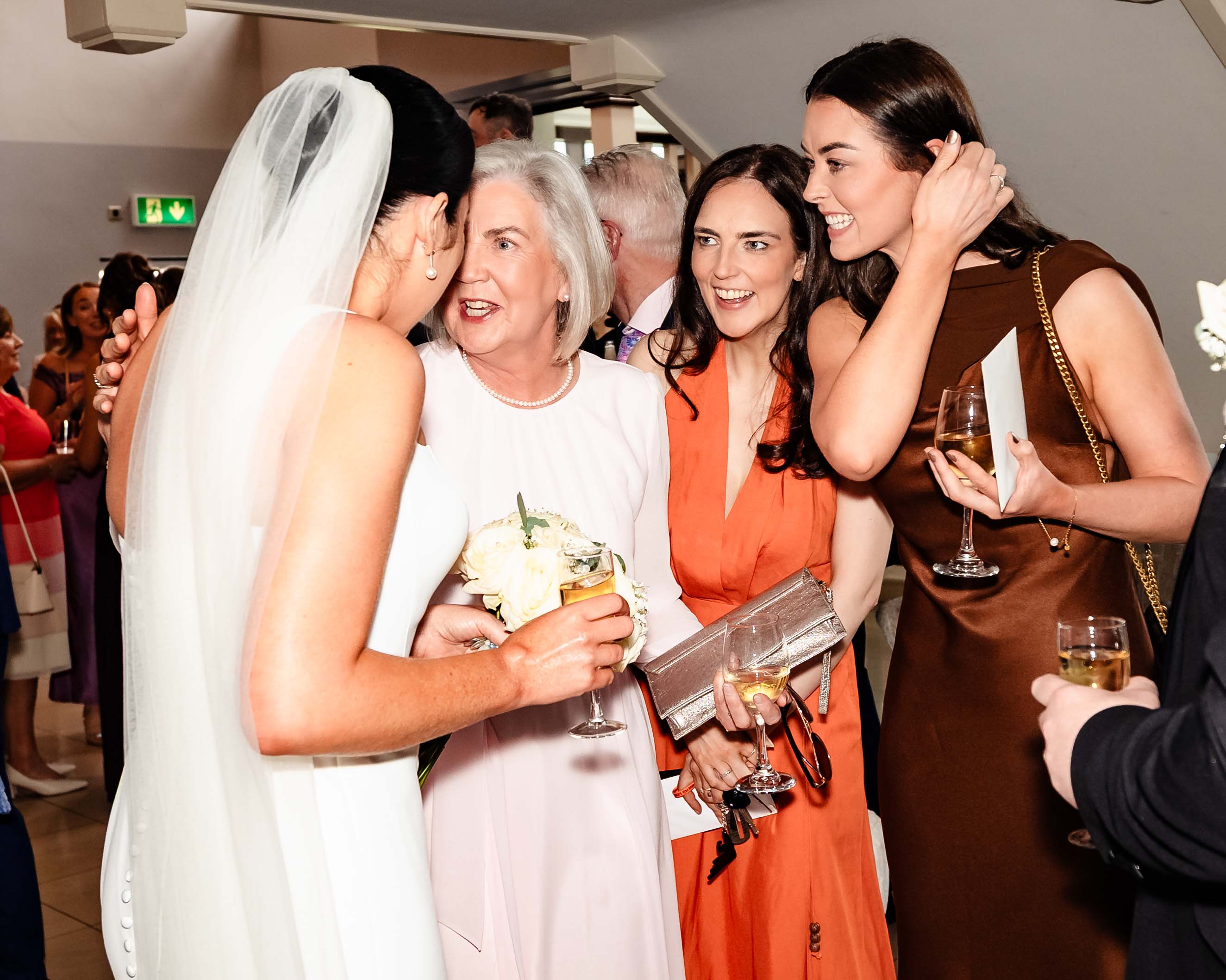 Guests cheering bride and groom at wedding reception – JOD Photography