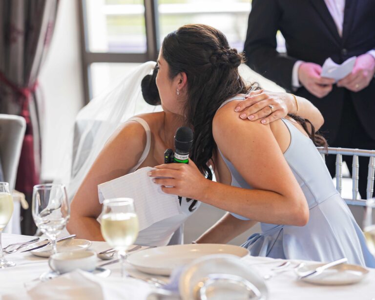 Bride hugging a guest during the speeches at the wedding reception, Kenmare Bay Hotel