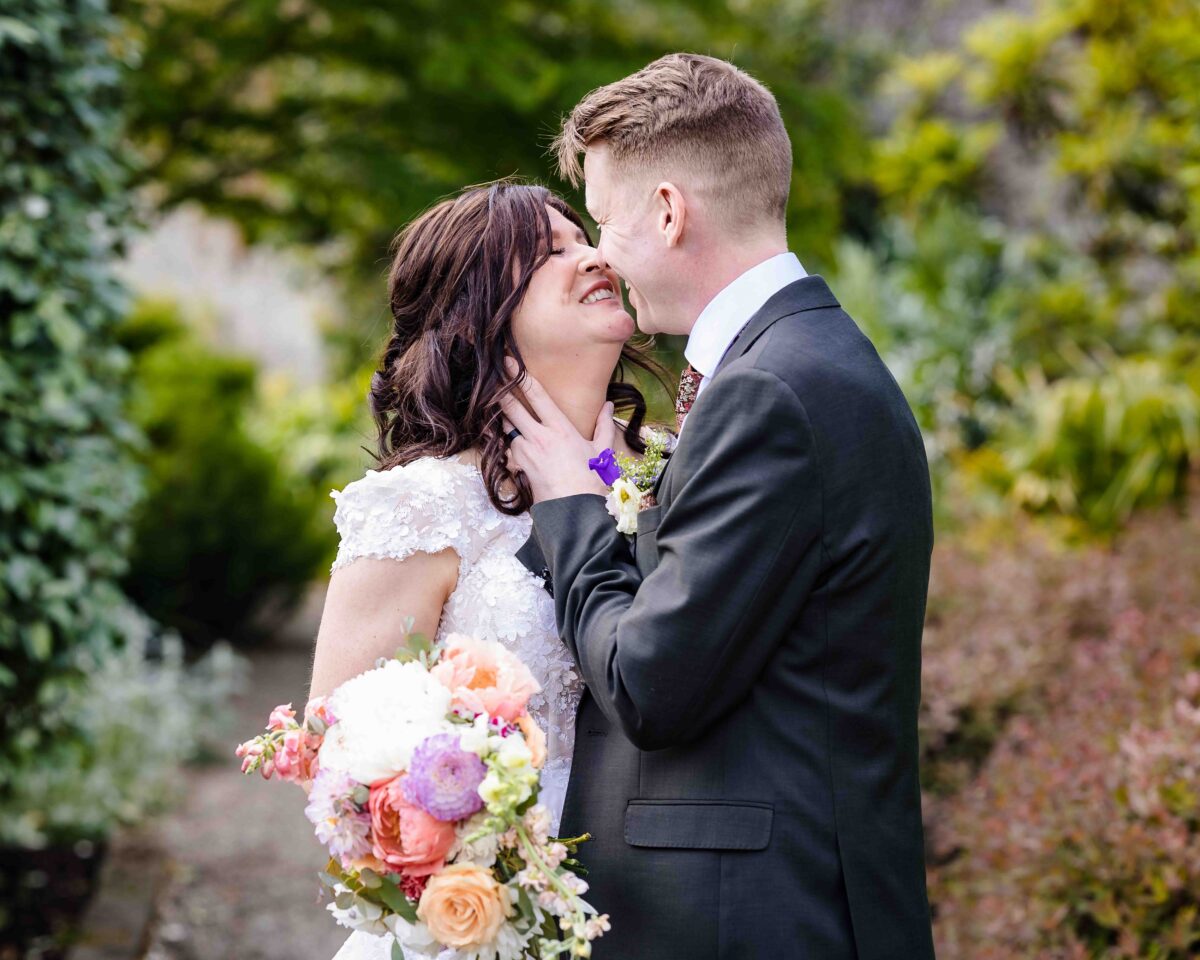 Bride and groom walking through Vandeleur Walled Garden in County Clare