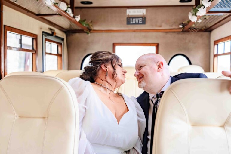 Bride and groom laughing together inside a vintage wedding bus, Cork wedding