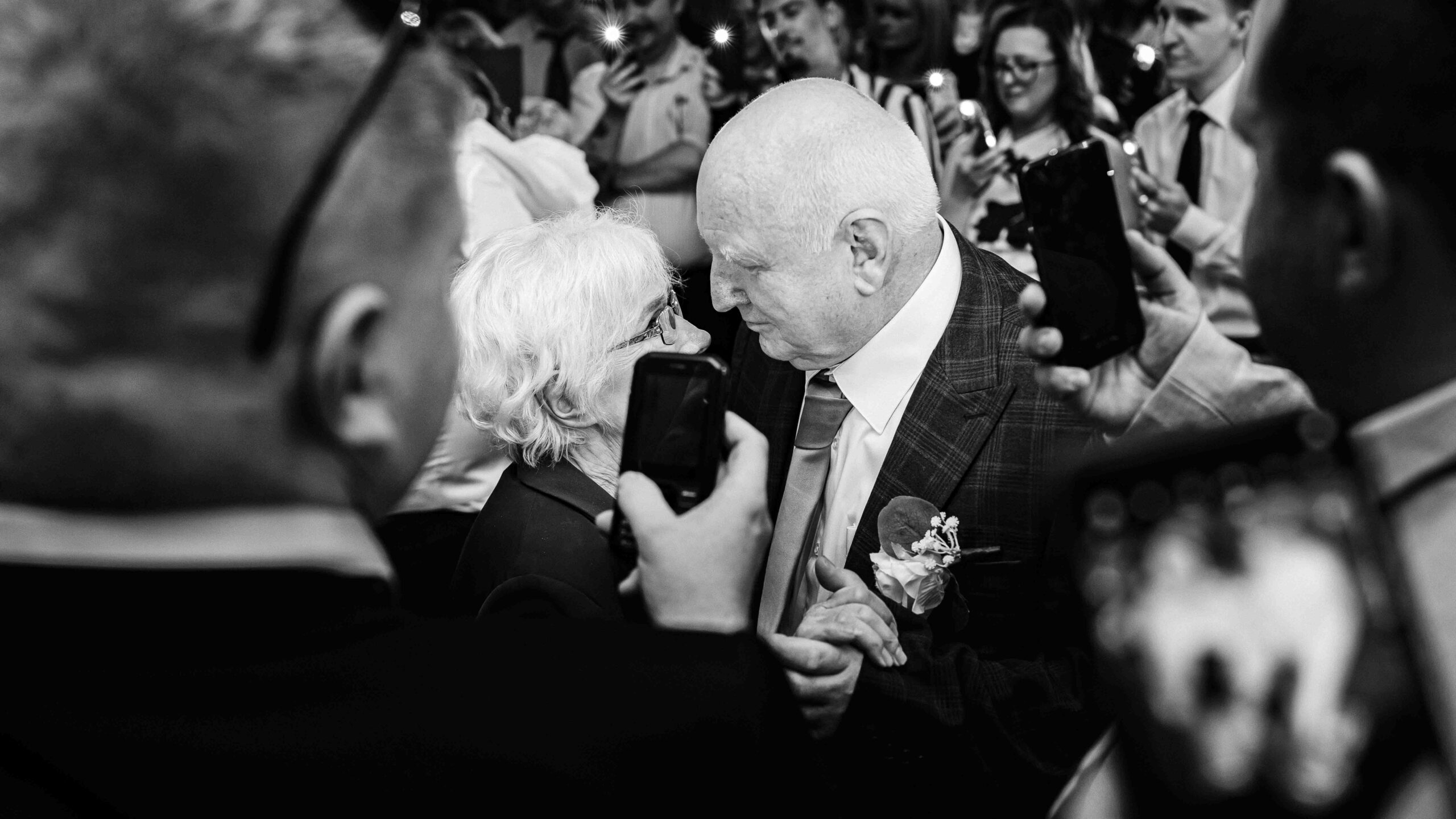 Guests celebrating on packed wedding dance floor