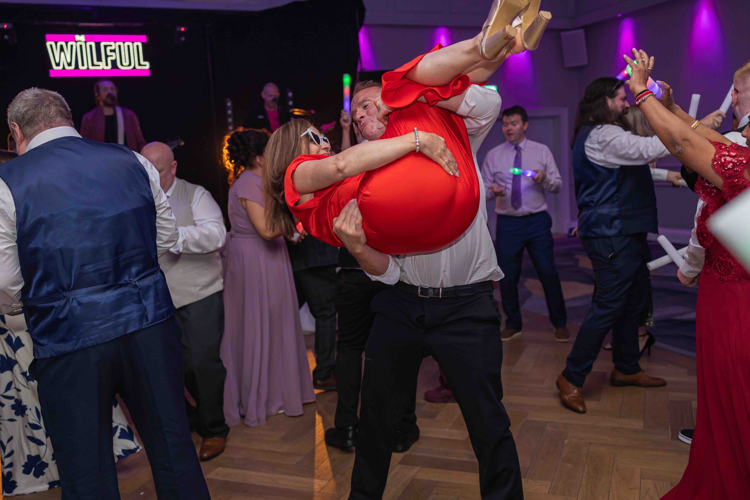 Guests celebrating on packed wedding dance floor