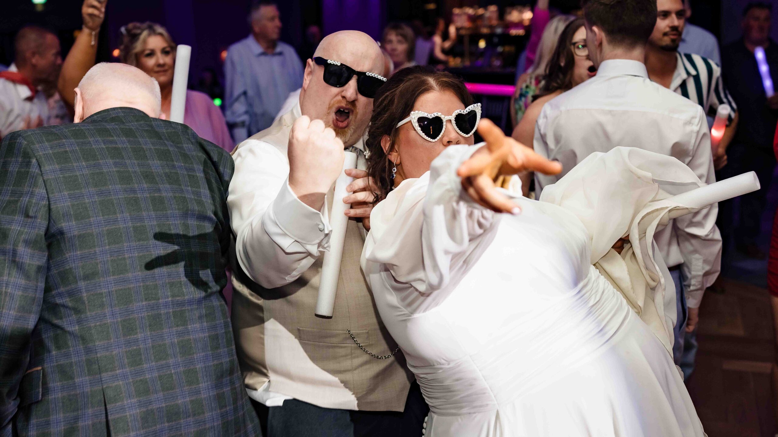 Guests celebrating on packed wedding dance floor