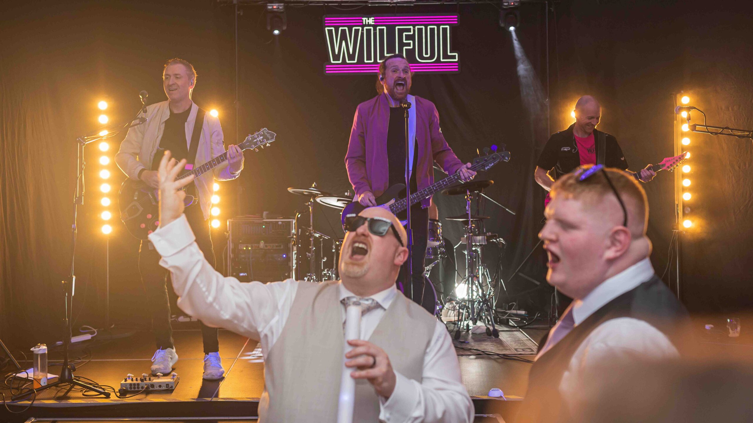 Guests celebrating on packed wedding dance floor