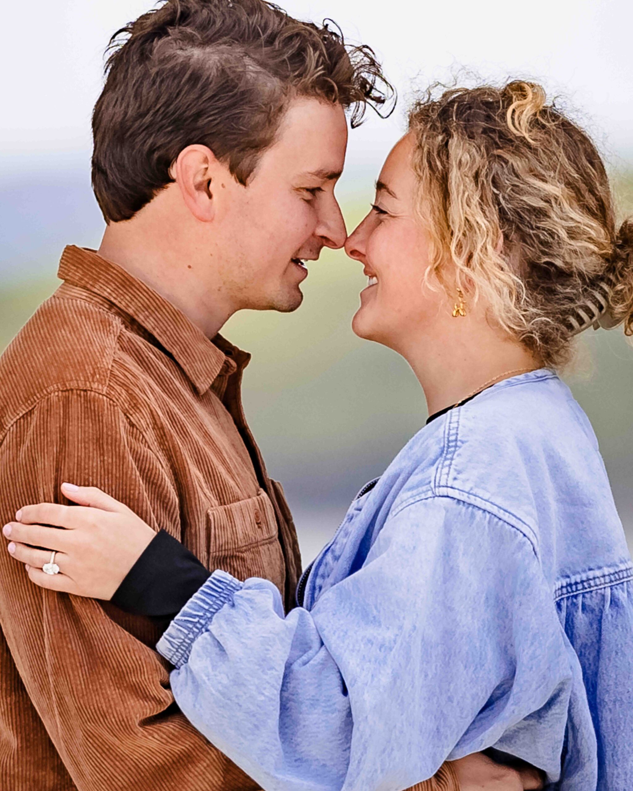 Newly engaged couple walking through Charles Fort
