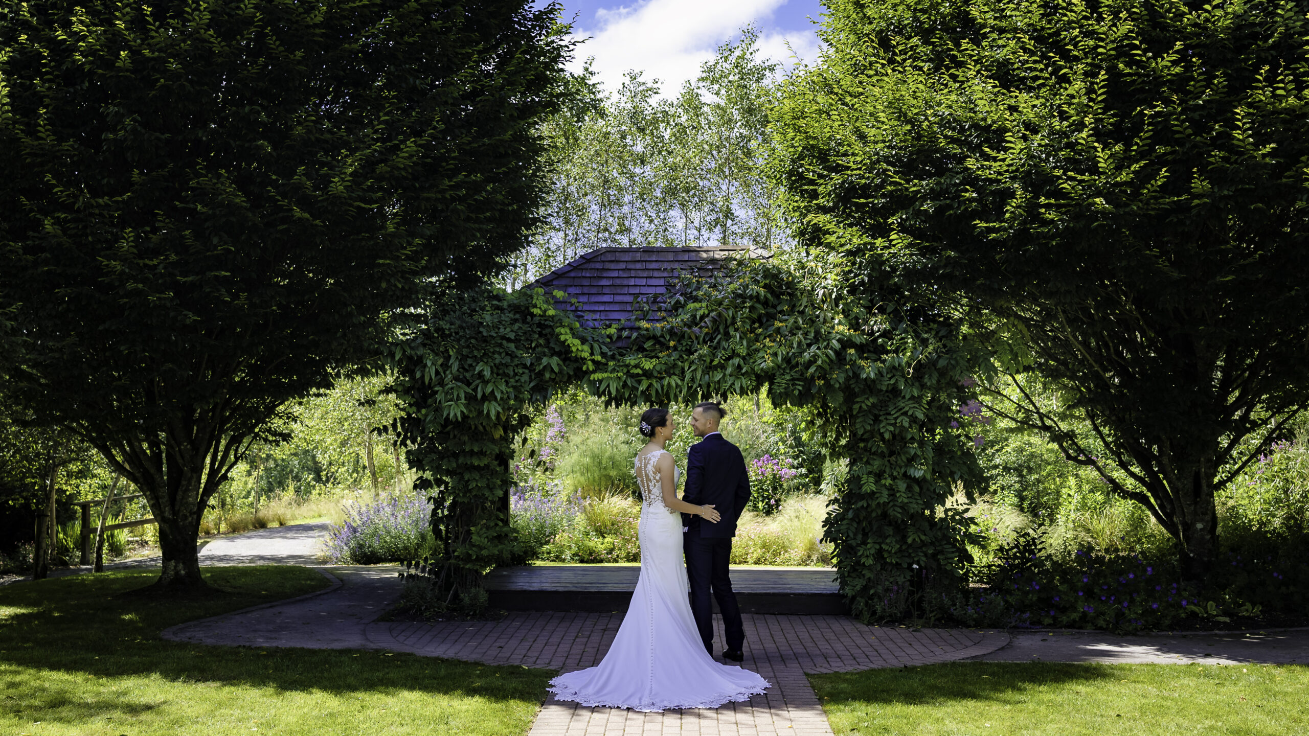 Wedding guests enjoying the grounds of Fernhill House Hotel & Gardens