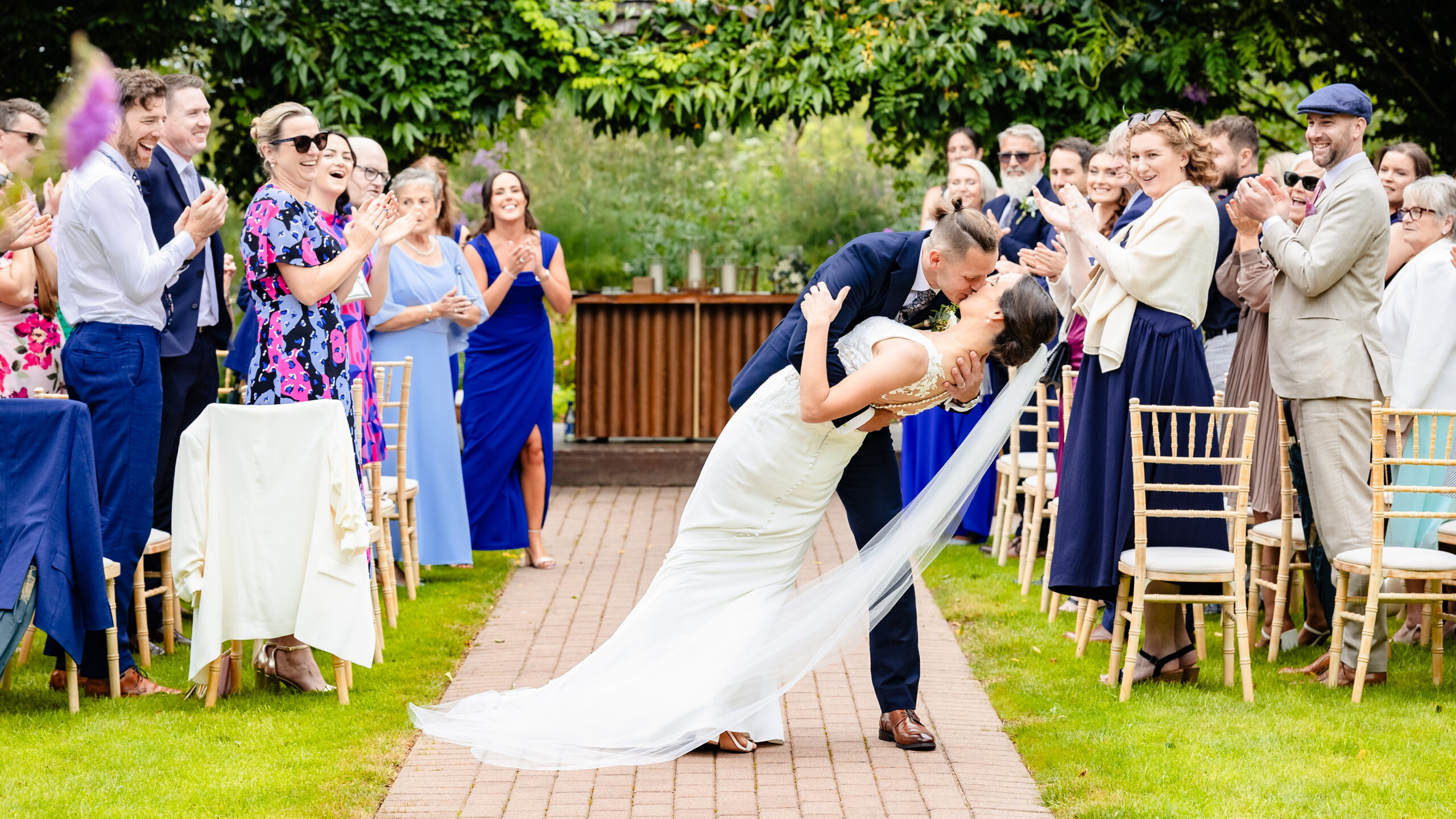 Newlyweds walking through the beautiful gardens at Fernhill House