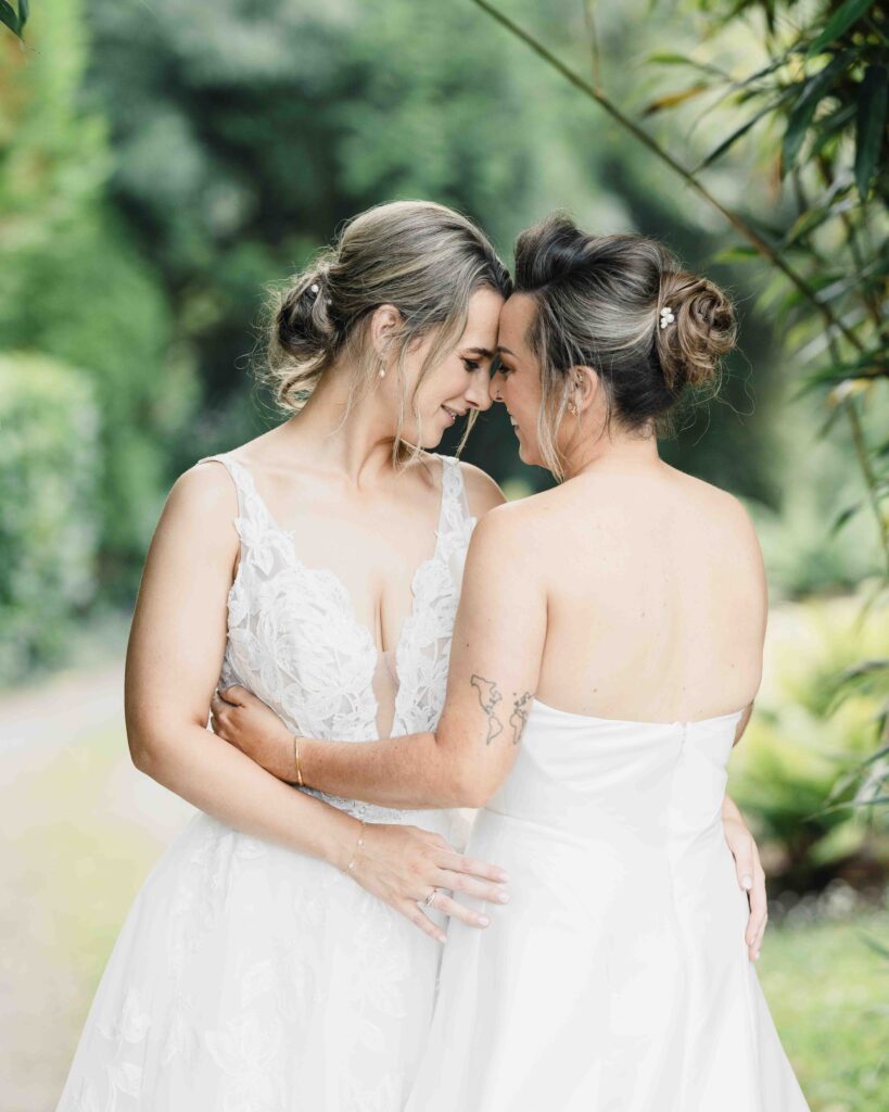 Bride and bride laughing together in the Fernhill House gardens – JOD Photography