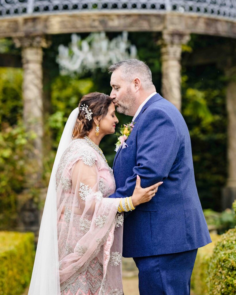 Monita walking down the aisle with her father during her emotional Ballyseede Castle wedding in Kerry.