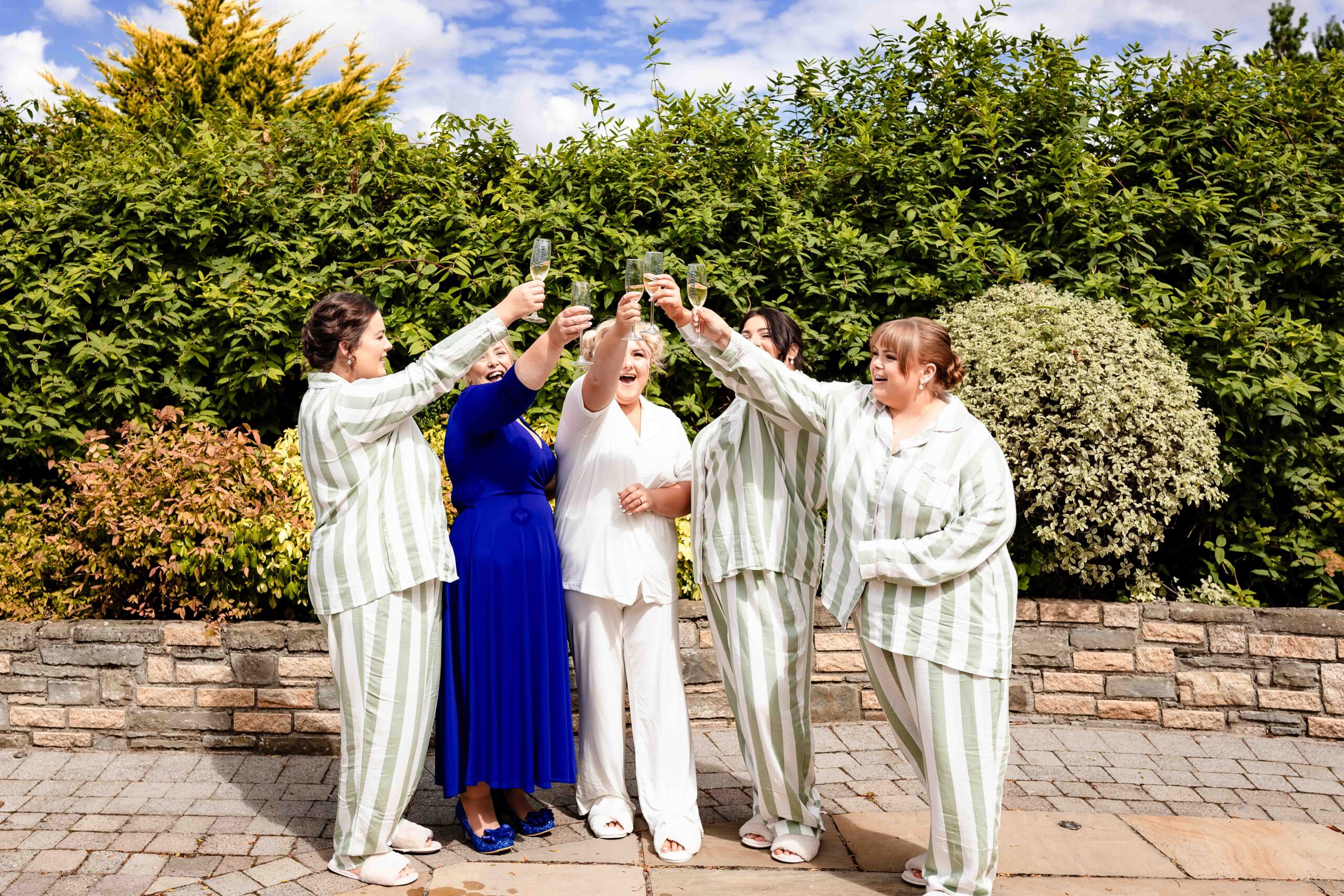 Caitlin laughing with family and friends during wedding photographs