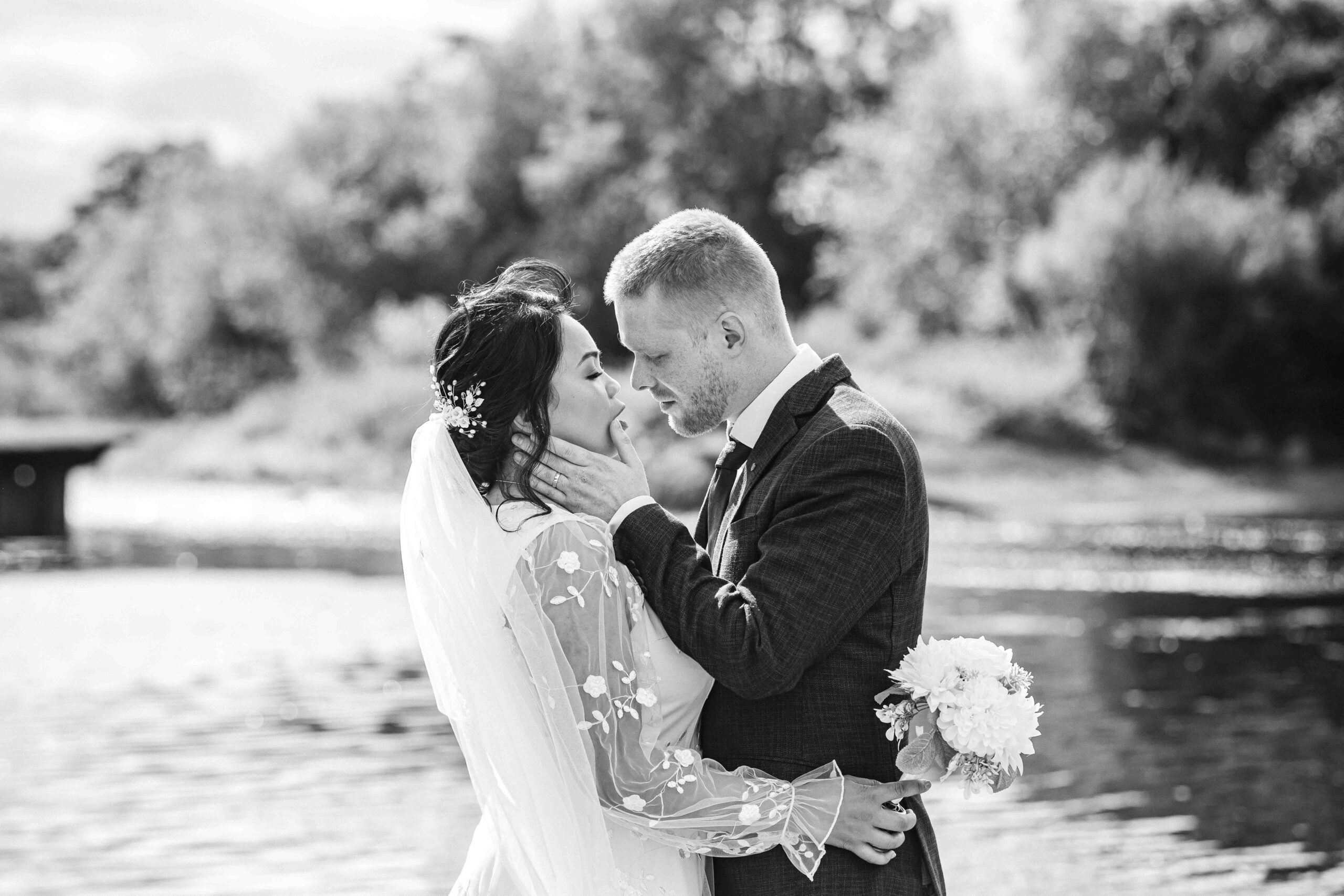 Audrey and Ben beside the river during their Ballincollig Regional Park wedding photographs