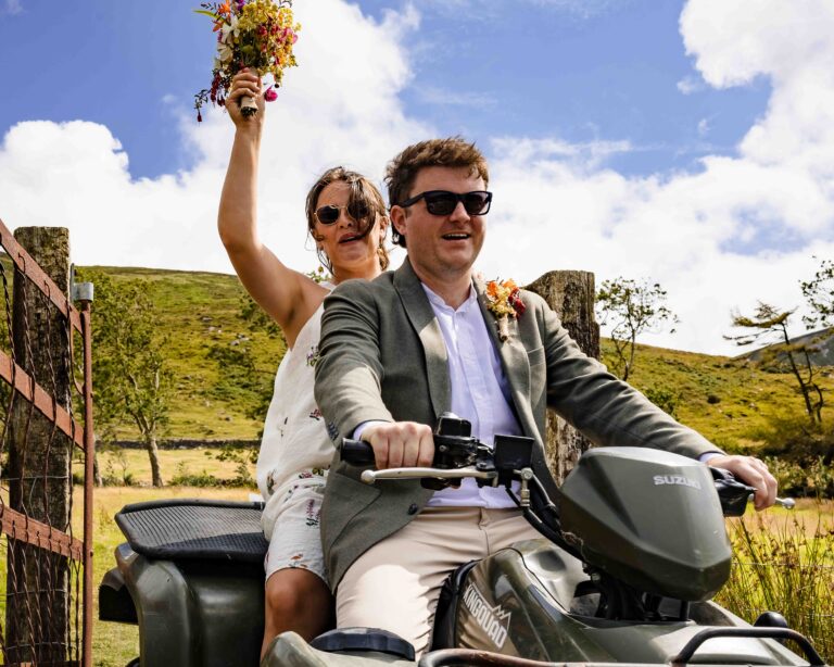 Newly married Aíne and Ciarán walking hand in hand along a quiet Kerry road