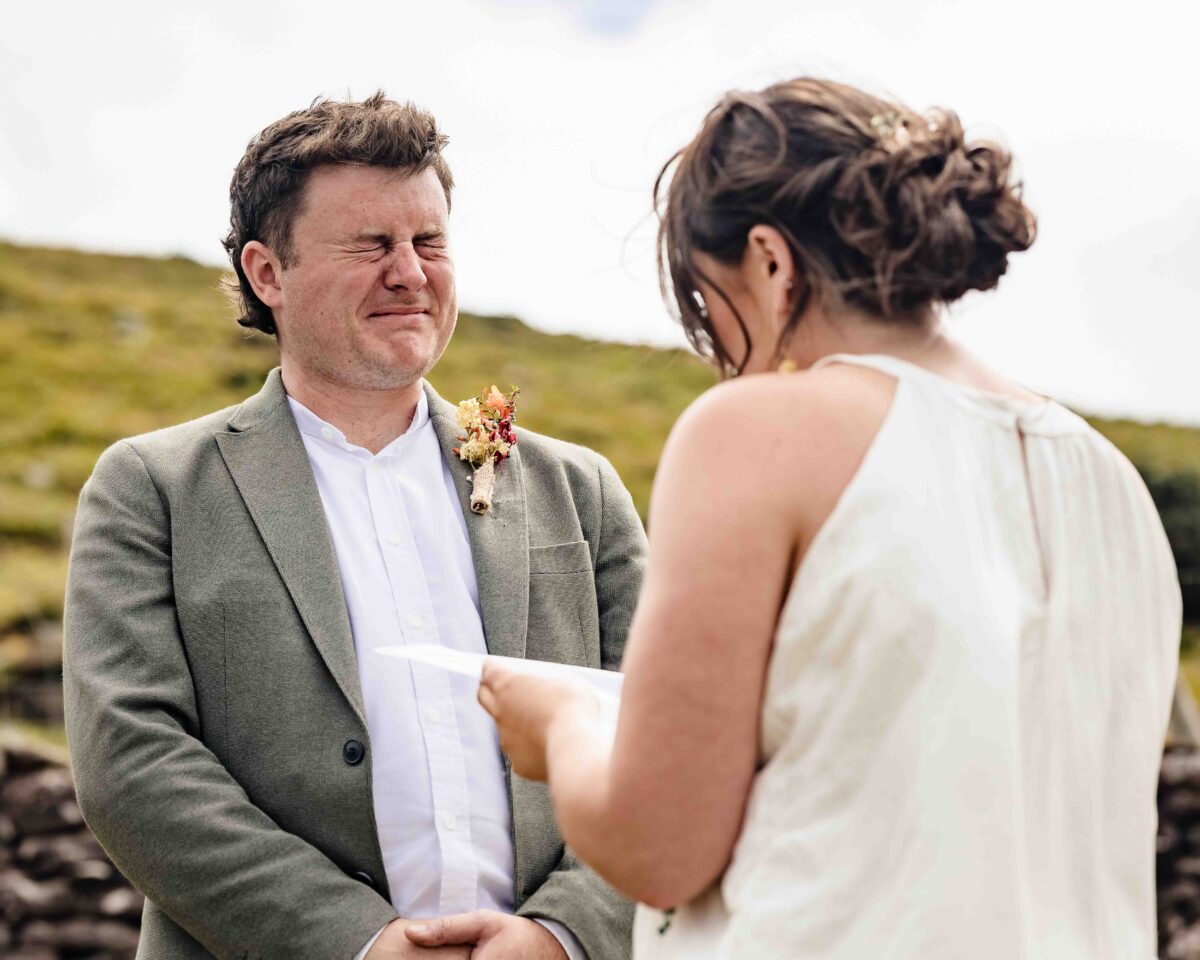 Groom holding back tears as his bride reads her vows at a West Kerry elopement