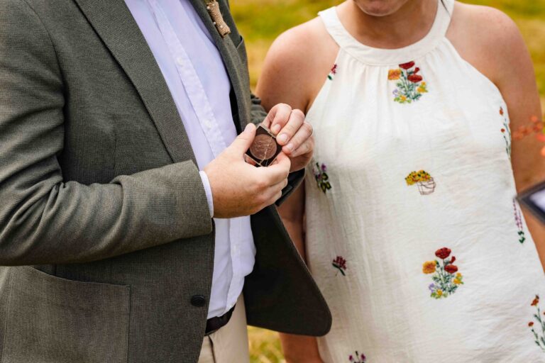 Couple's hands holding a coin during their intimate West Kerry elopement ceremony