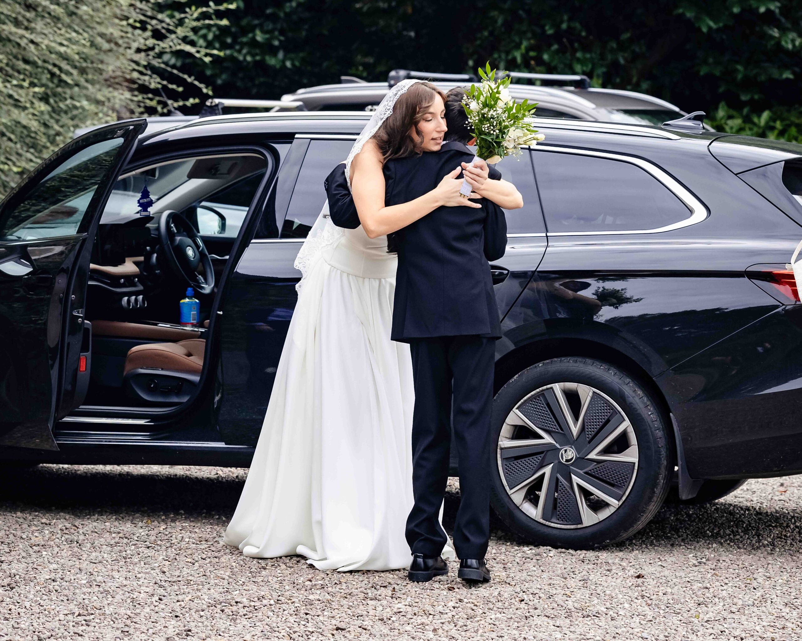 Bride Andzelika hugging her son Joseph before her woodland wedding ceremony – JOD Photography