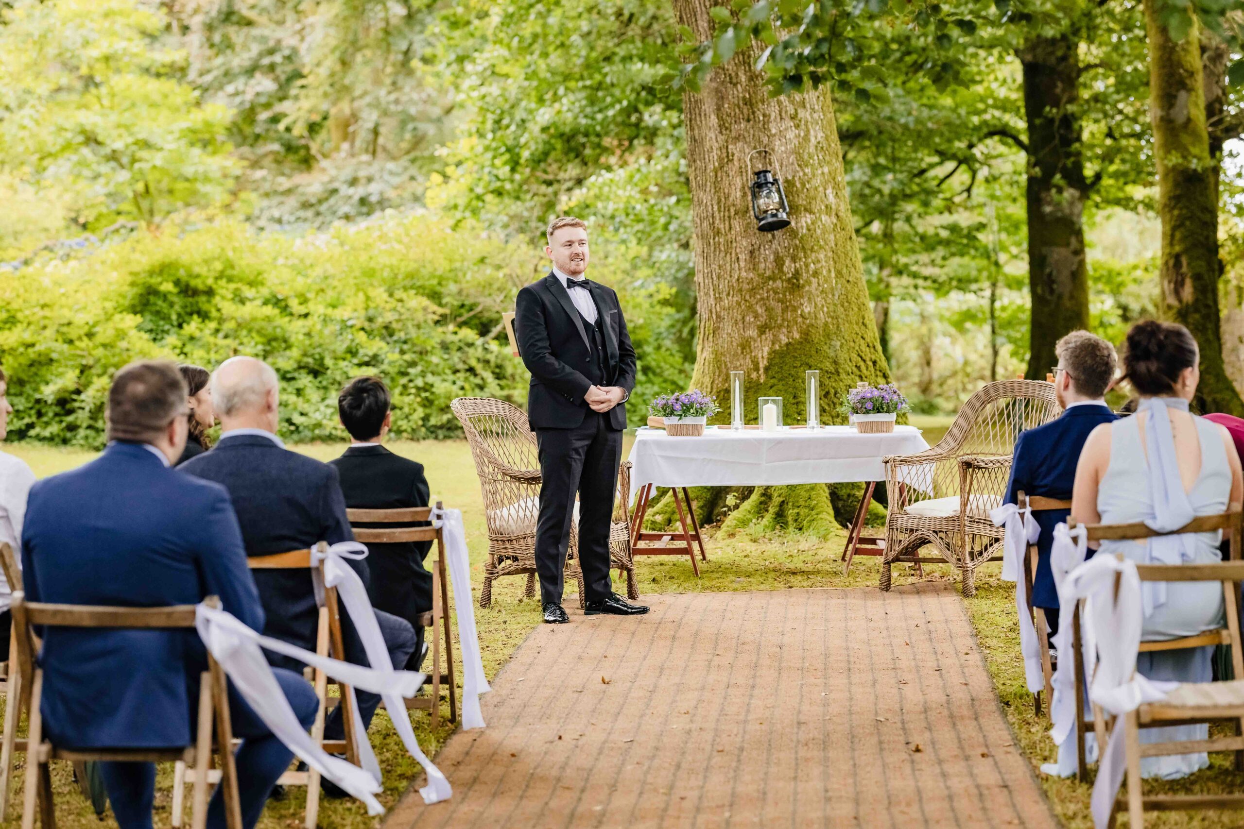 Evan watching Andzelika arrive for their outdoor wedding ceremony – JOD Photography