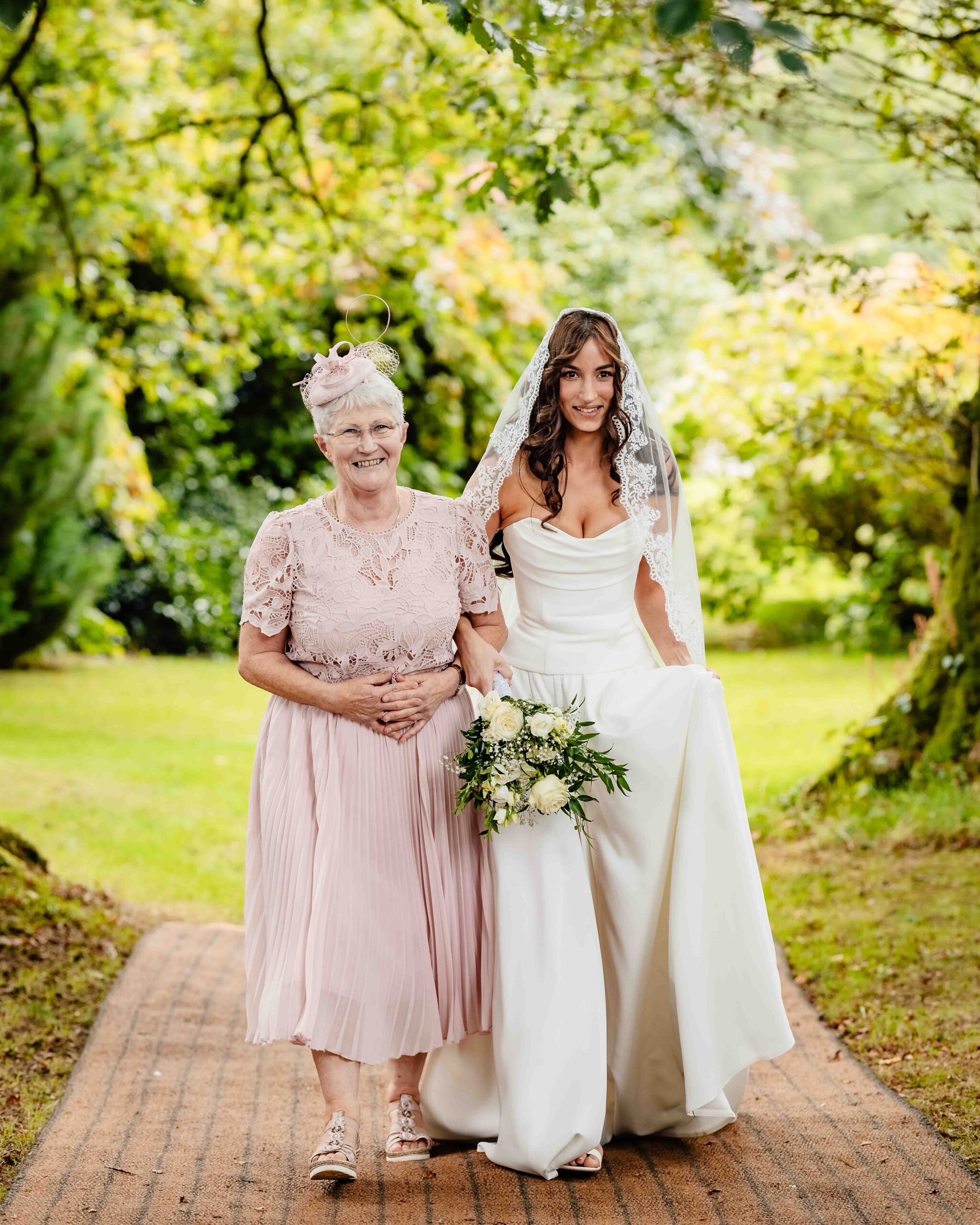 Andzelika appearing through the trees at her Ballyvolane House wedding ceremony – JOD Photography