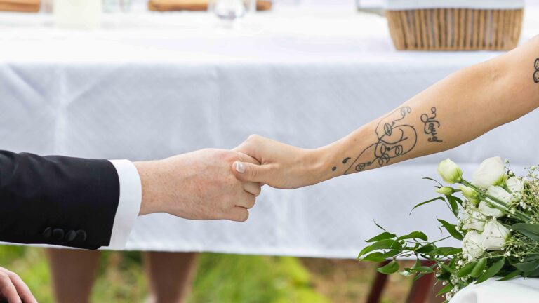 Close-up of the bride and groom holding hands with a tattoo visible at Ballyvolane House wedding