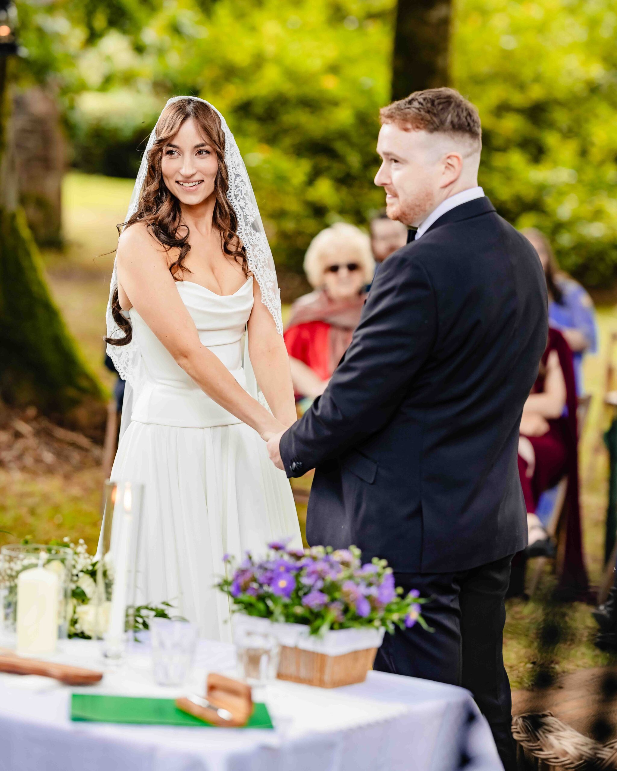 Andzelika and Evan exchanging vows beneath the trees at Ballyvolane House – JOD Photography