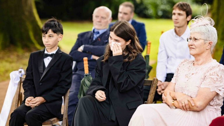 Guests wiping away tears during the ceremony at Ballyvolane House wedding, County Cork