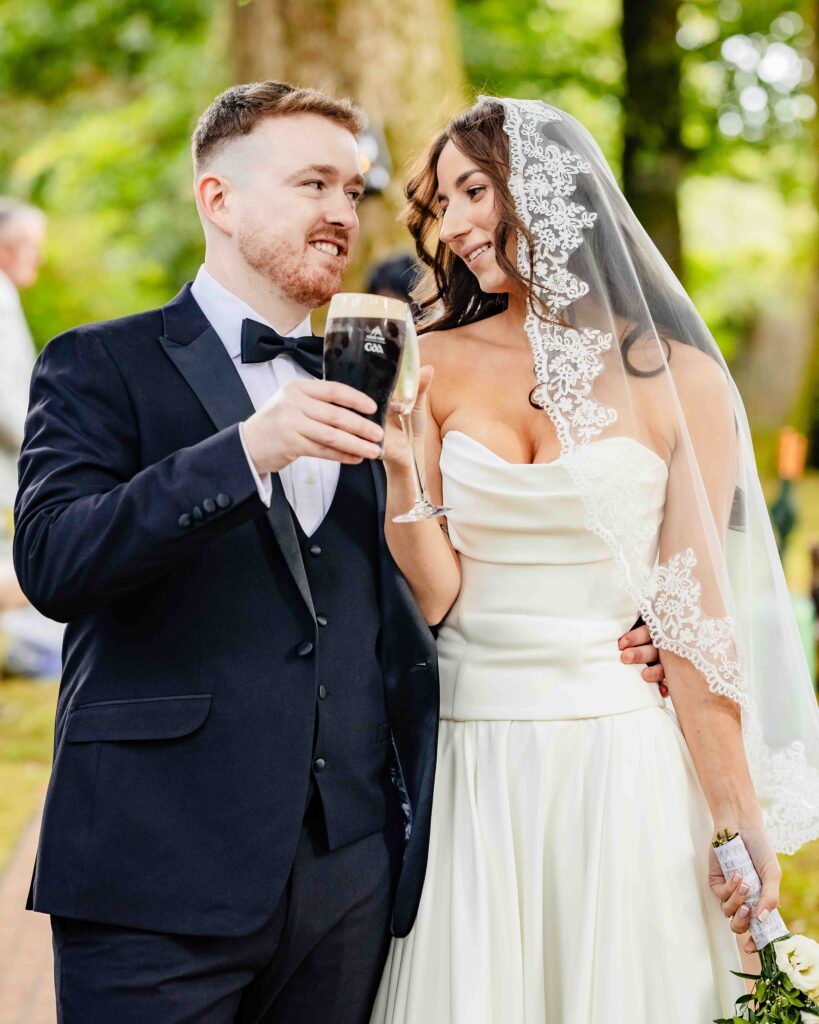 Bride and groom toasting with champagne at their Ballyvolane House wedding, County Cork