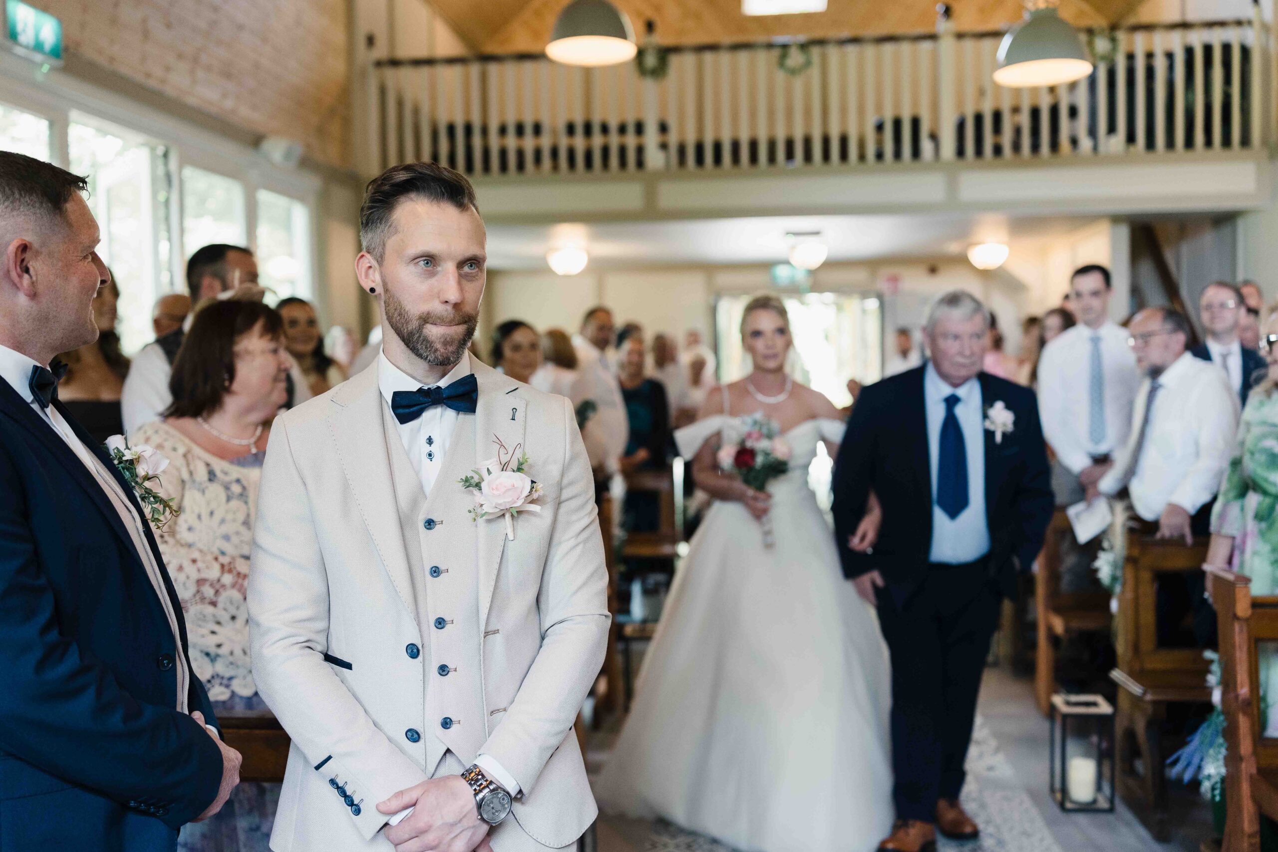 Wedding guests laughing during Shane and Suzy's celebration at The Village Barn
