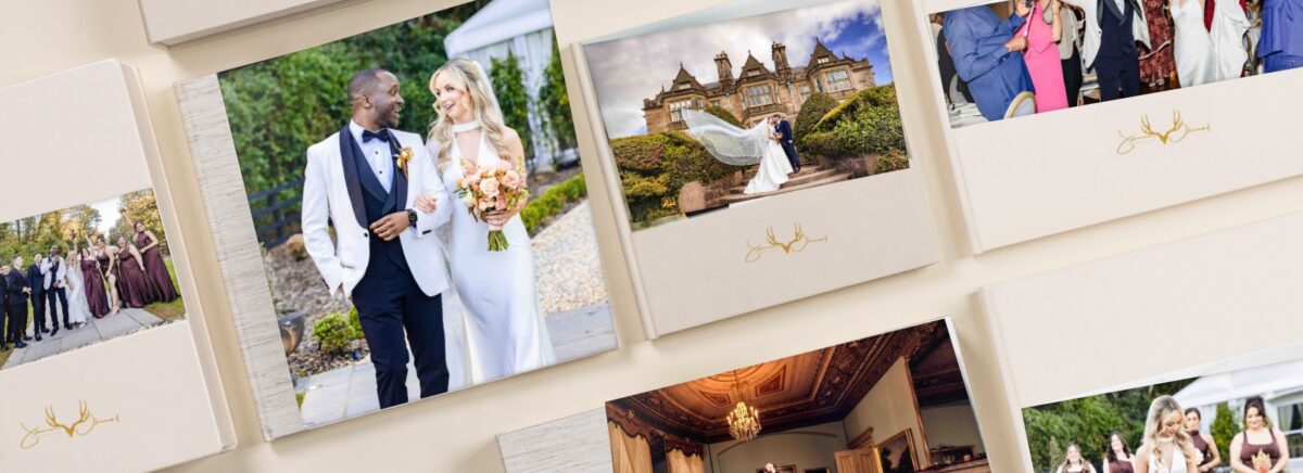 A collection of cream linen wedding albums and boxes showing JOD Photography wedding photographs