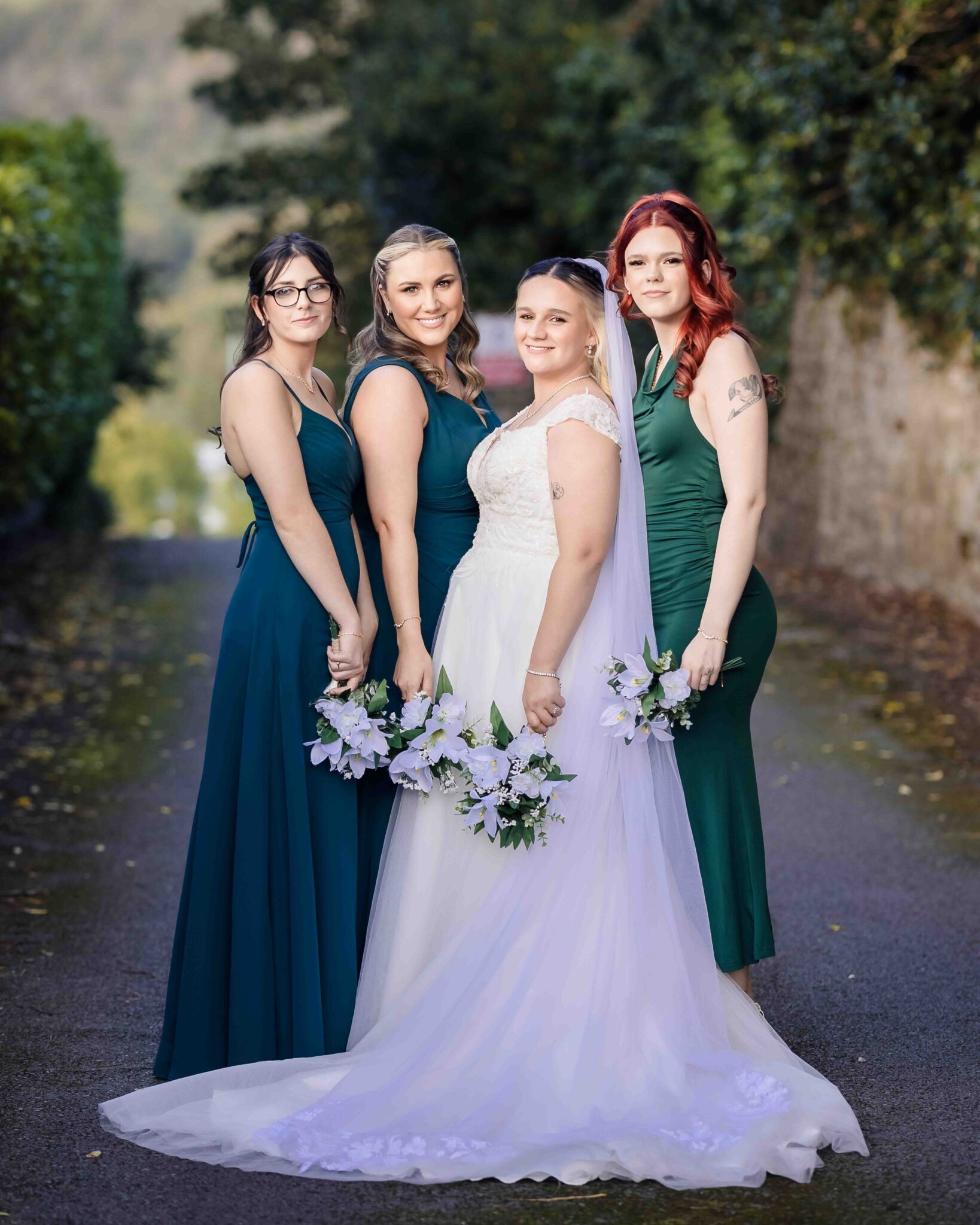 Shannon with her bridesmaids in teal green dresses on the walkway at the Talbot Hotel Cork wedding