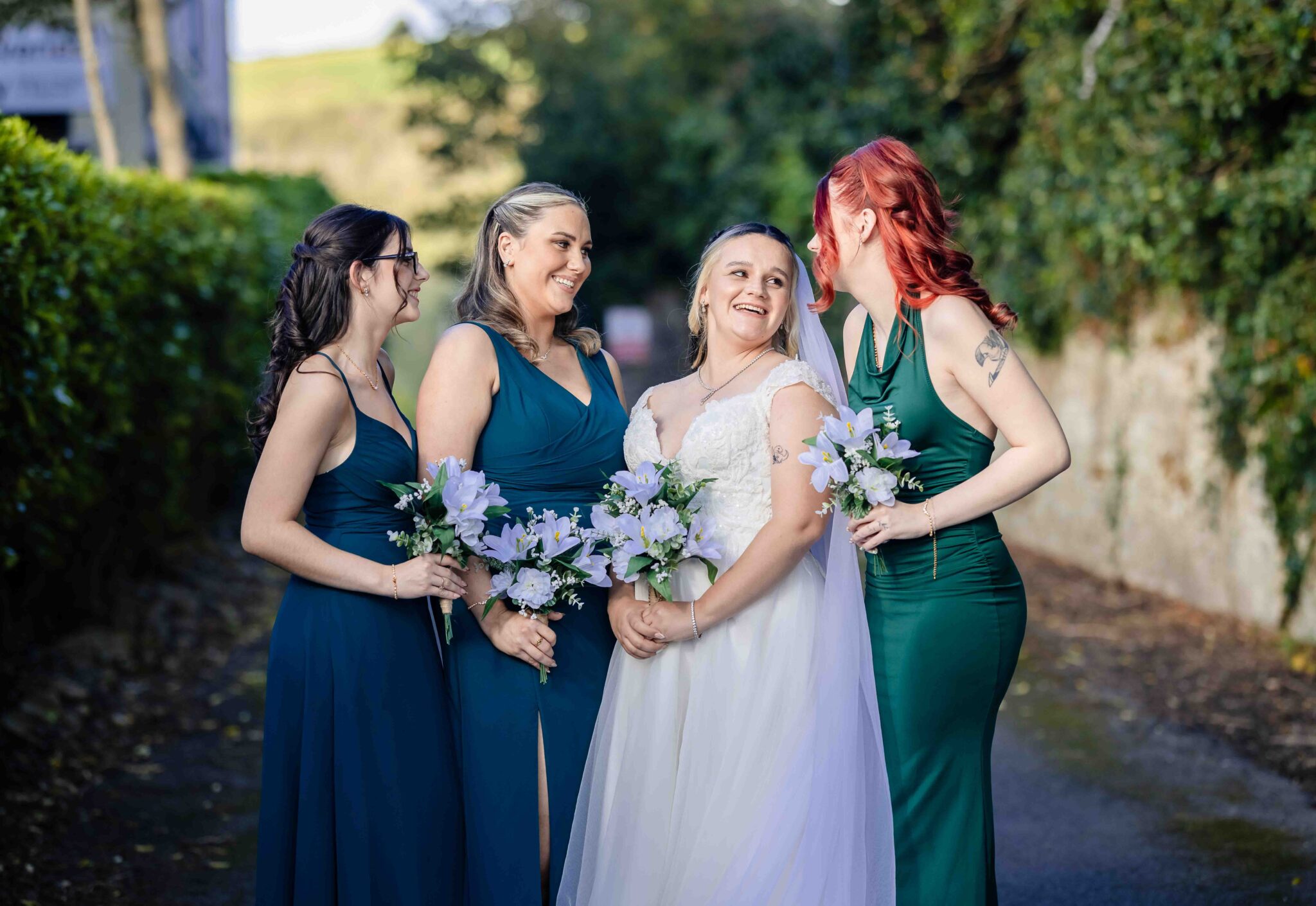Shannon and her bridesmaids in green dresses laugh together beside the Talbot Hotel Cork, Cork wedding photography
