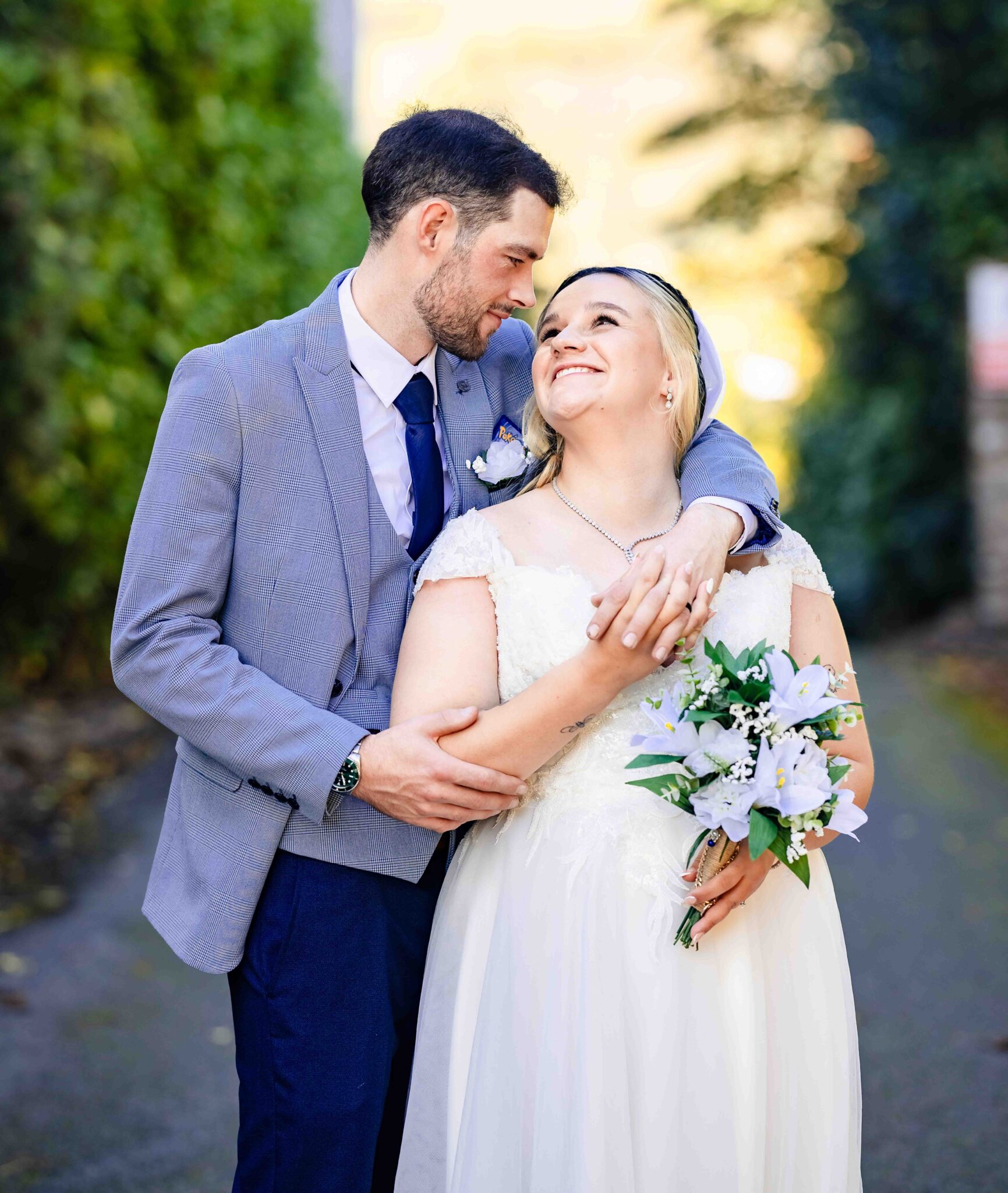 Brandon holds Shannon close as she looks up at him on the walkway beside the Talbot Hotel Cork, autumn wedding portrait
