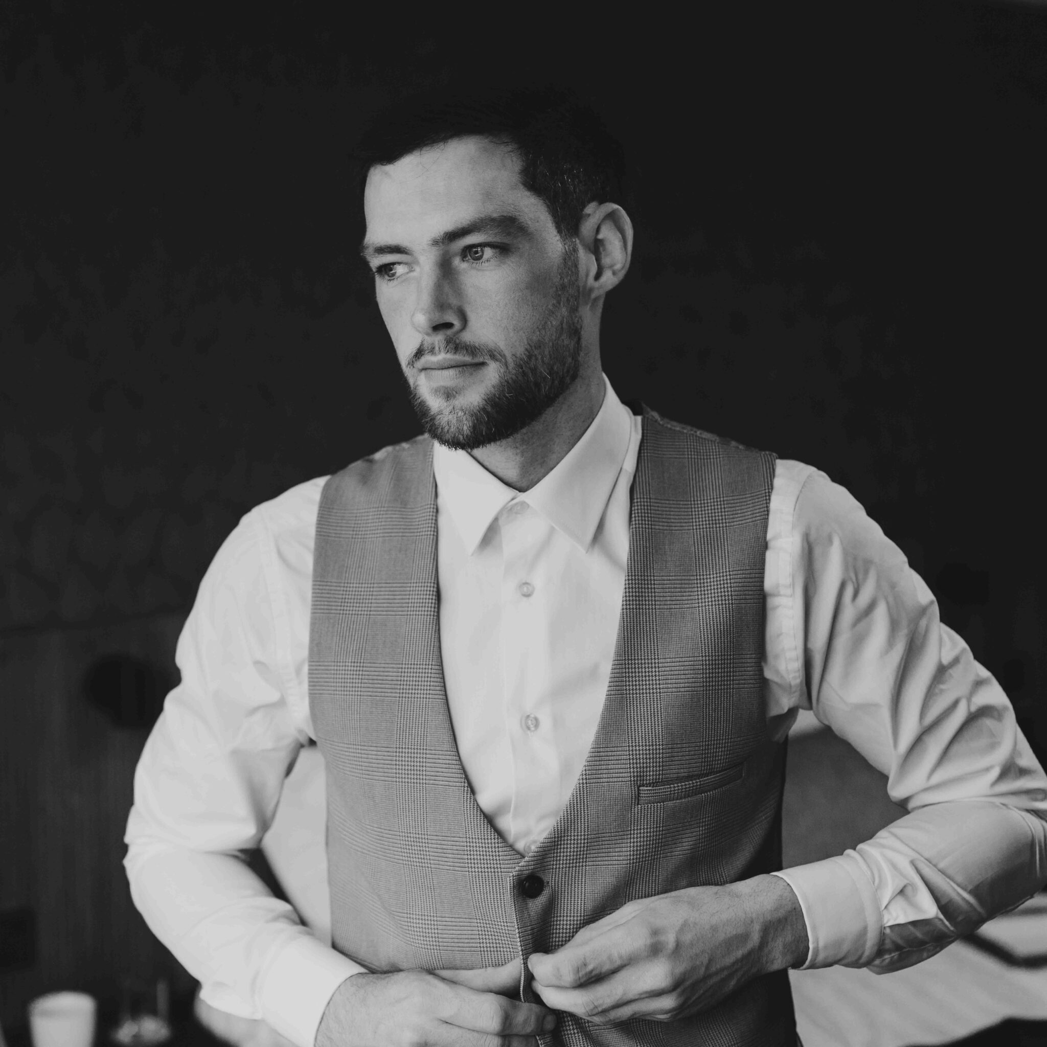 Black and white portrait of Brandon in his waistcoat on the morning of the Talbot Hotel Cork wedding
