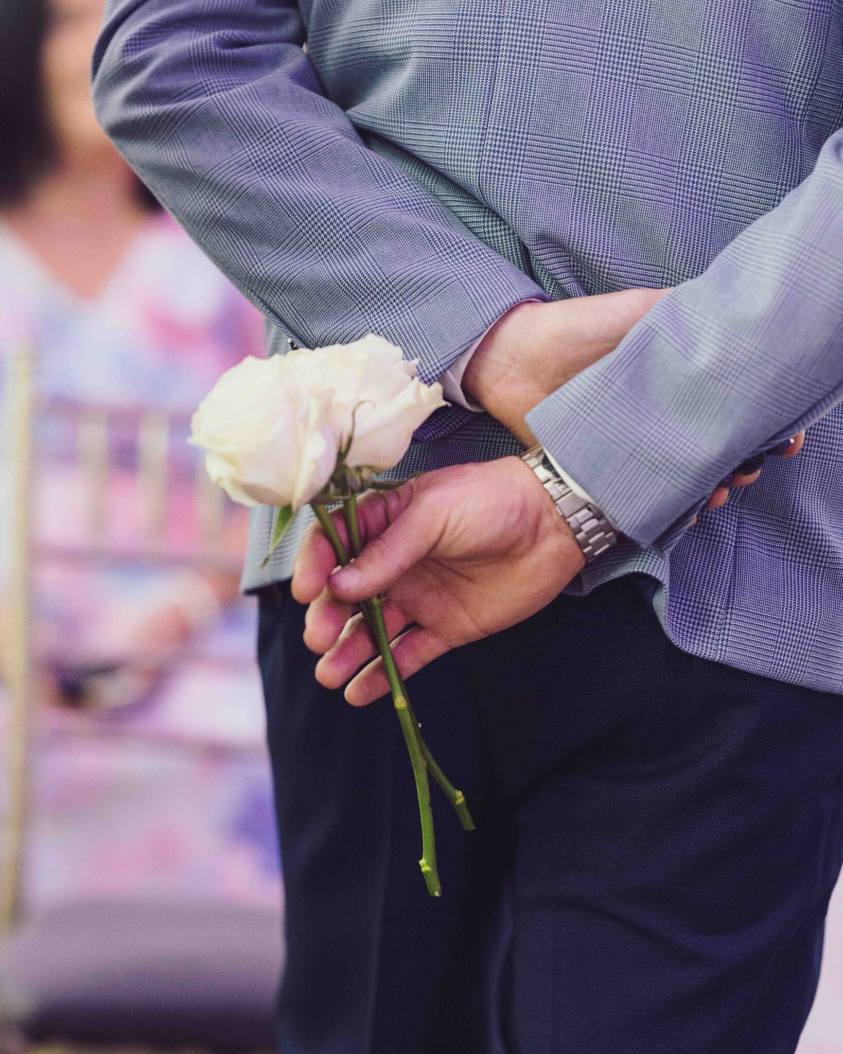 Guest holds a white flower behind his back before the ceremony at the Talbot Hotel Cork wedding