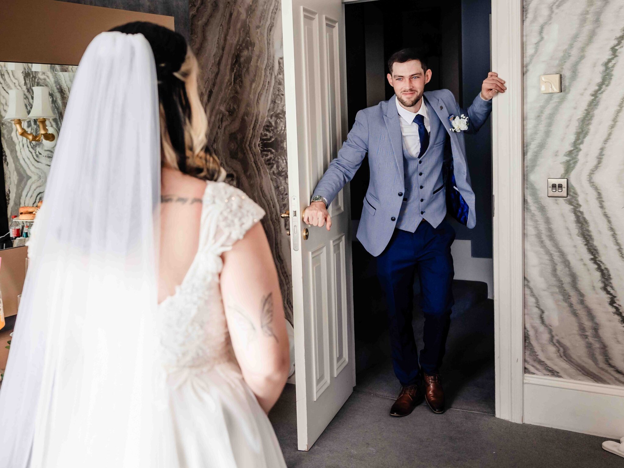 Brandon steps through the door for his first look with Shannon at the Talbot Hotel Cork wedding