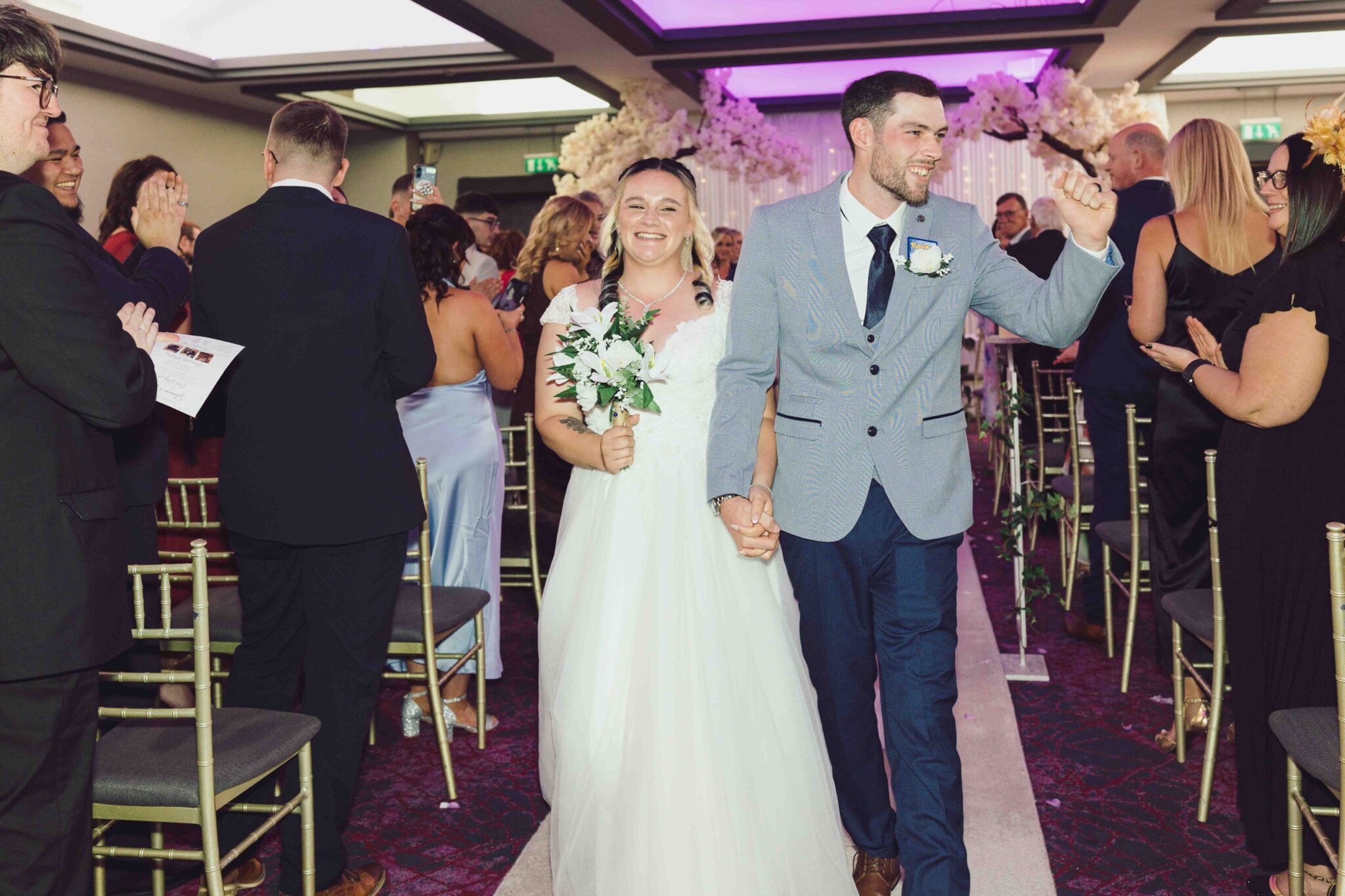 Shannon and Brandon walk back down the aisle married, both beaming, at the Talbot Hotel Cork wedding