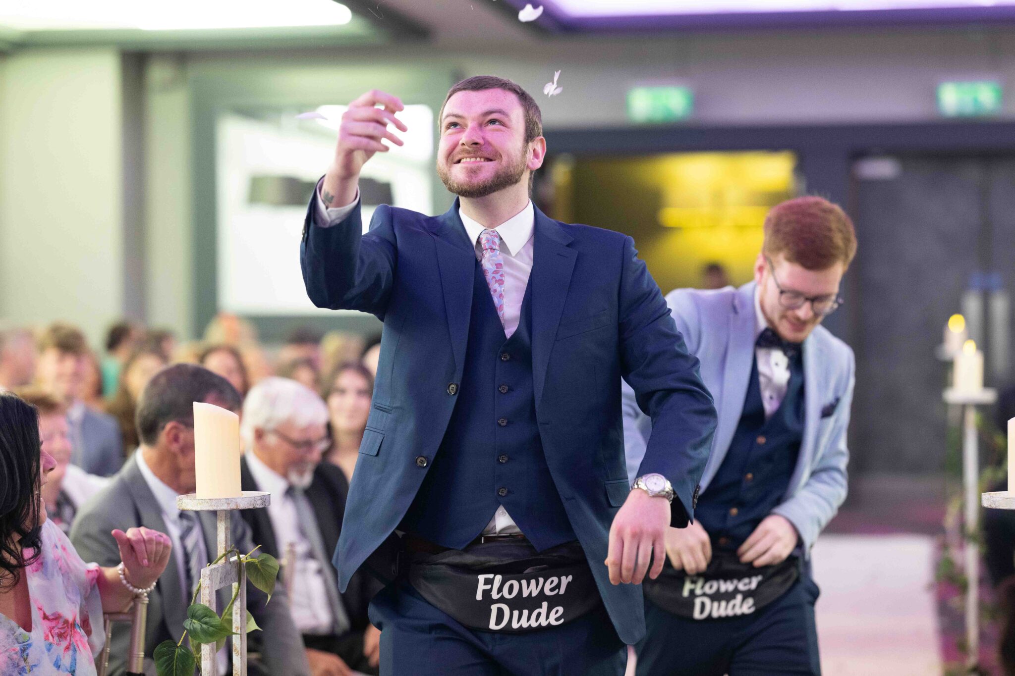 One of the Flower Dudes cheers and tosses flowers down the aisle at the Talbot Hotel Cork wedding ceremony