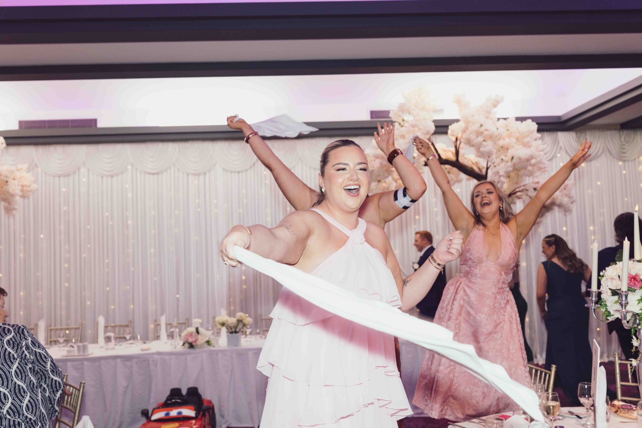 Bridesmaids wave white napkins and cheer on the dance floor at the Talbot Hotel Cork wedding