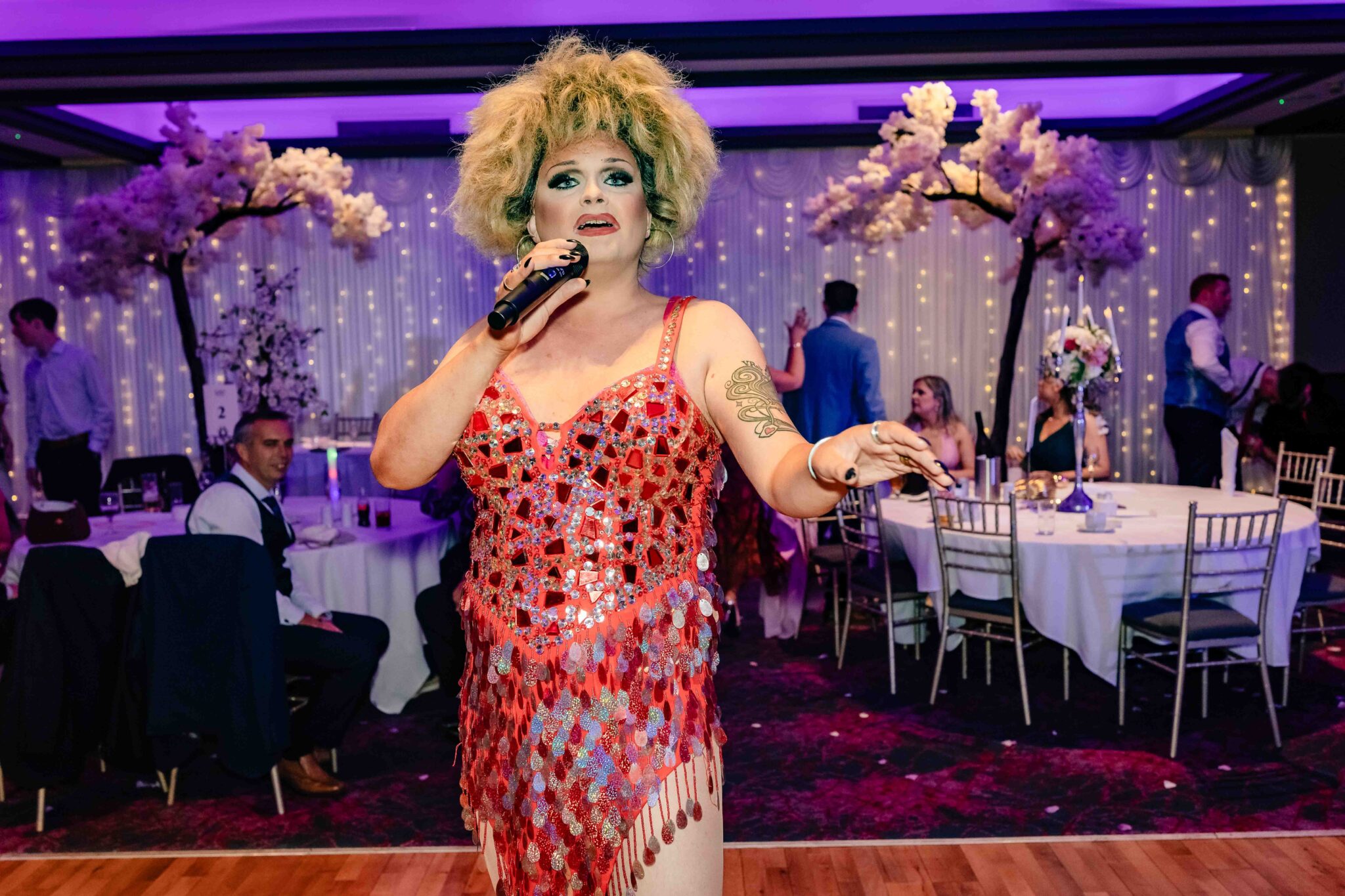 Singer in a red sequin dress performs for the crowd at the Talbot Hotel Cork wedding reception