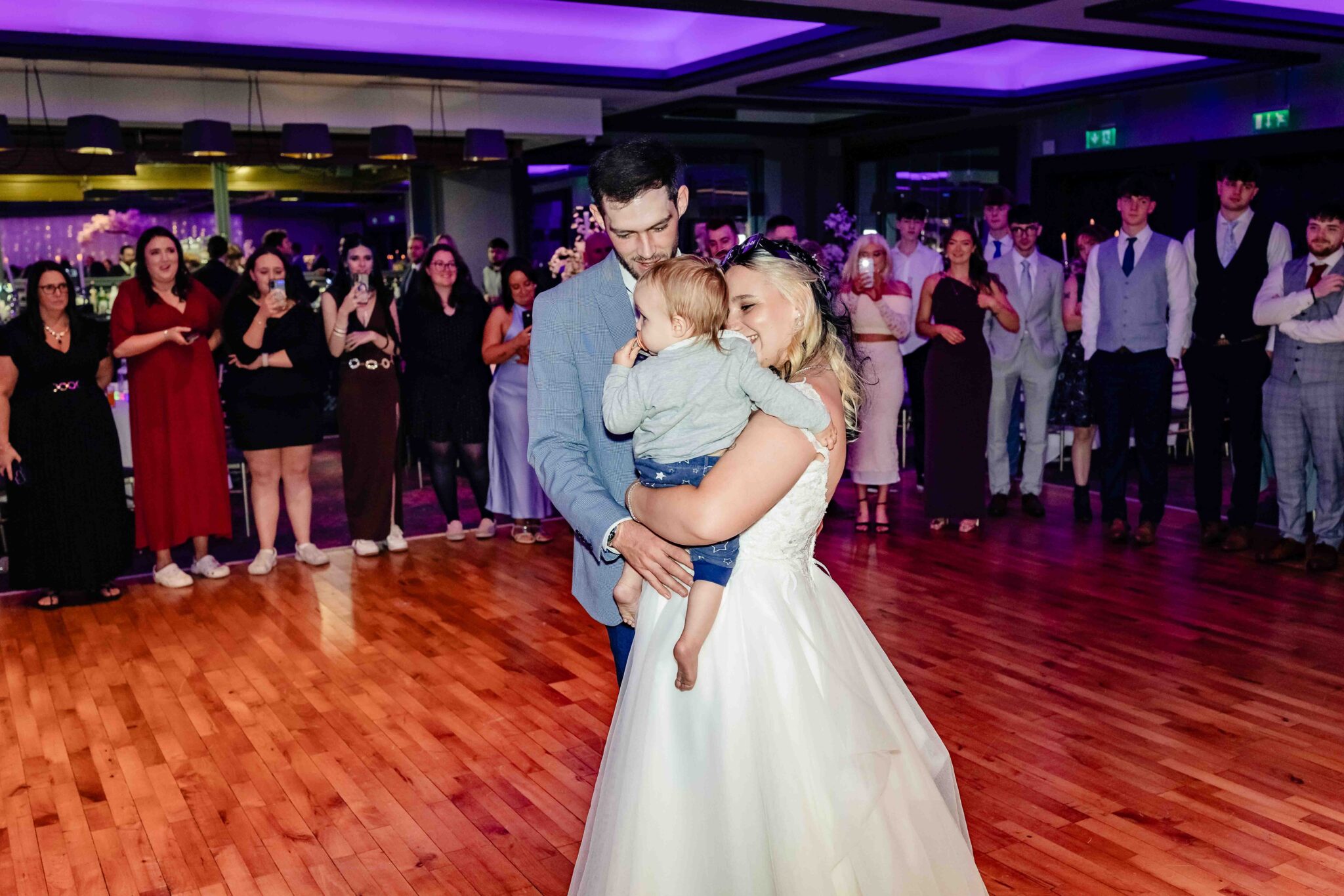 Shannon and Brandon dance holding a toddler at the Talbot Hotel Cork wedding reception